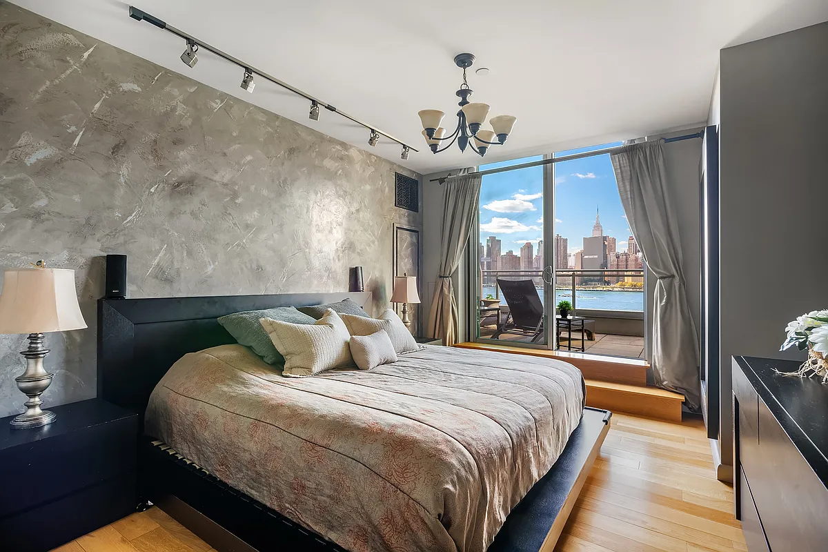 46-30 Center Boulevard, Unit 710 Queens, NY 11109 - Photo 4 of 25 a bedroom with a large bed and a chandelier