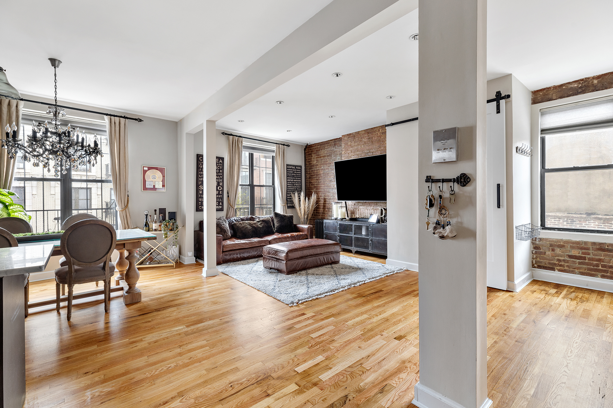 167 Grand Street, Unit 2 Brooklyn, NY 11249 - Photo 2 of 7 a living room with furniture flat screen tv and wooden floor