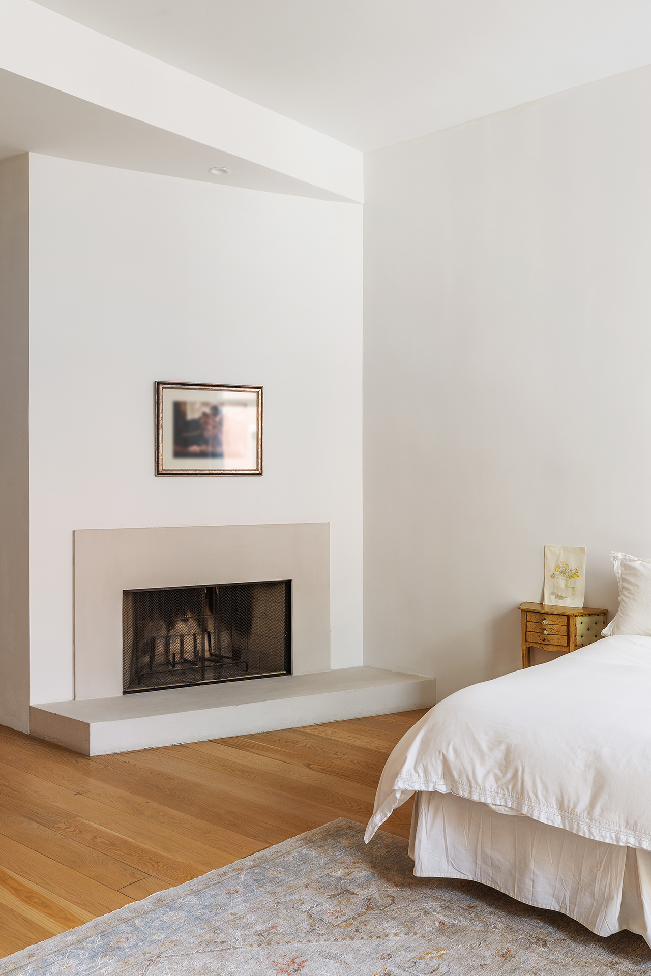 60 Warren Street, Unit 2 Manhattan, NY 10007 - Photo 9 of 16 a bedroom with a bed and a fireplace