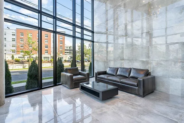 a living room with furniture and a floor to ceiling window