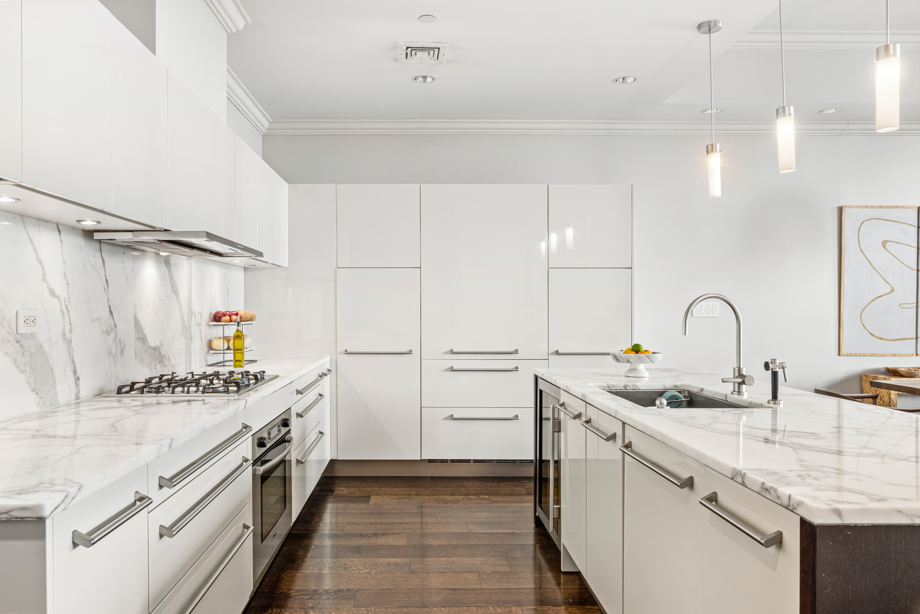 51 Walker Street, Unit 6B Manhattan, NY 10013 - Photo 5 of 10 a kitchen with stainless steel appliances a sink dishwasher and white cabinets with wooden floor