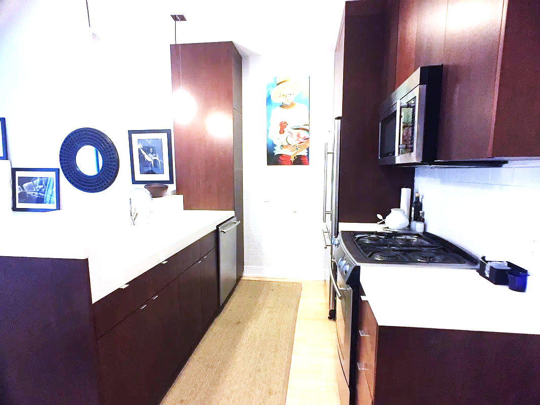 284 Warren Street, Unit 2 Brooklyn, NY 11201 - Photo 5 of 7 a kitchen with a sink a stove and cabinets