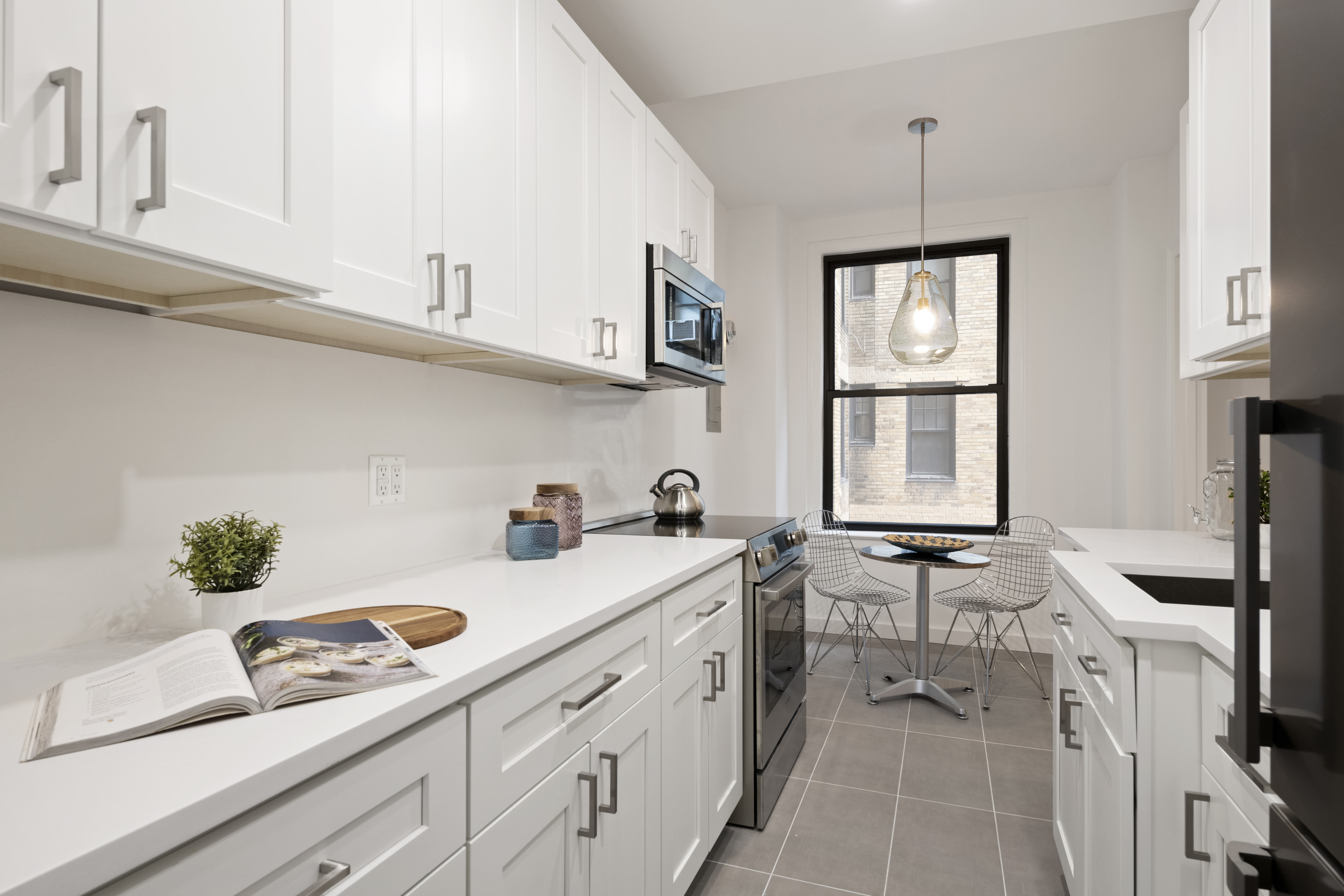 33 Riverside Drive, Unit 5D Manhattan, NY 10023 - Photo 4 of 7 a kitchen with stainless steel appliances a sink stove and cabinets