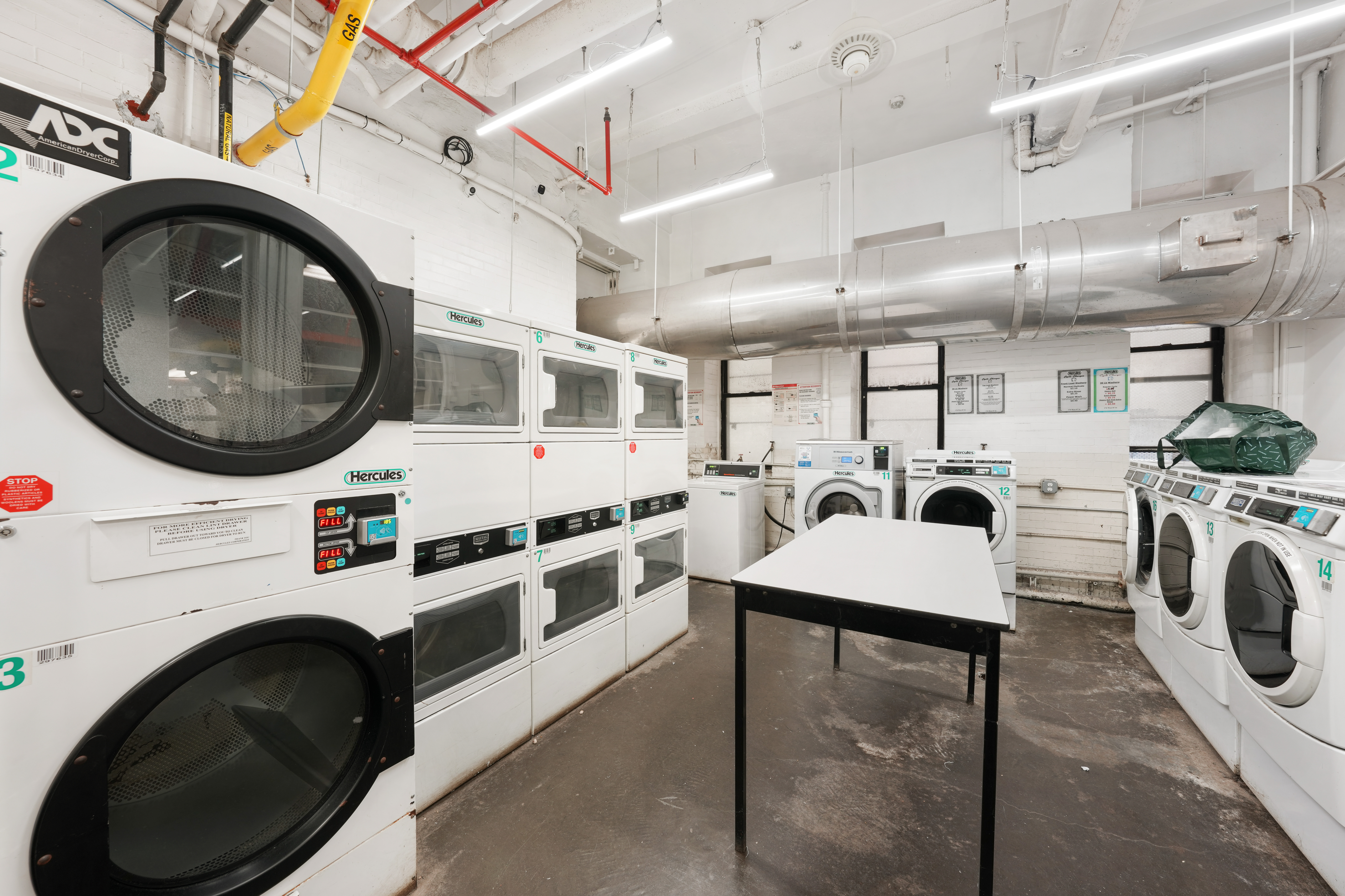 176 West 87th Street, Unit 1H Manhattan, NY 10024 - Photo 16 of 19 a utility room with dryer and washer