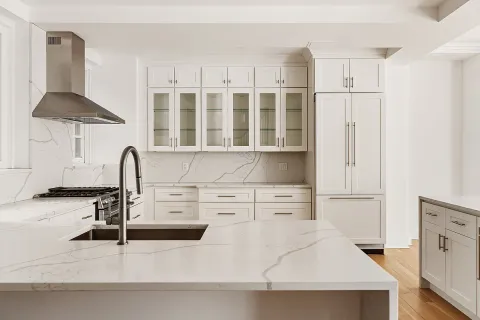 a kitchen with stainless steel appliances kitchen island a refrigerator sink and cabinets