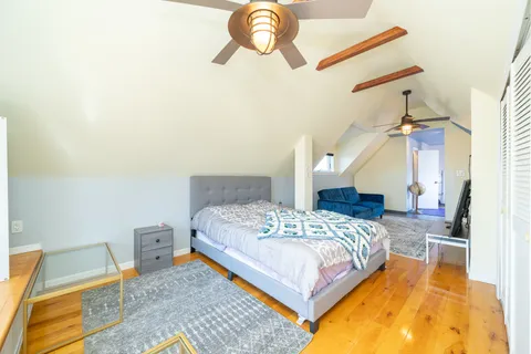 a bedroom with a bed dresser and a rug