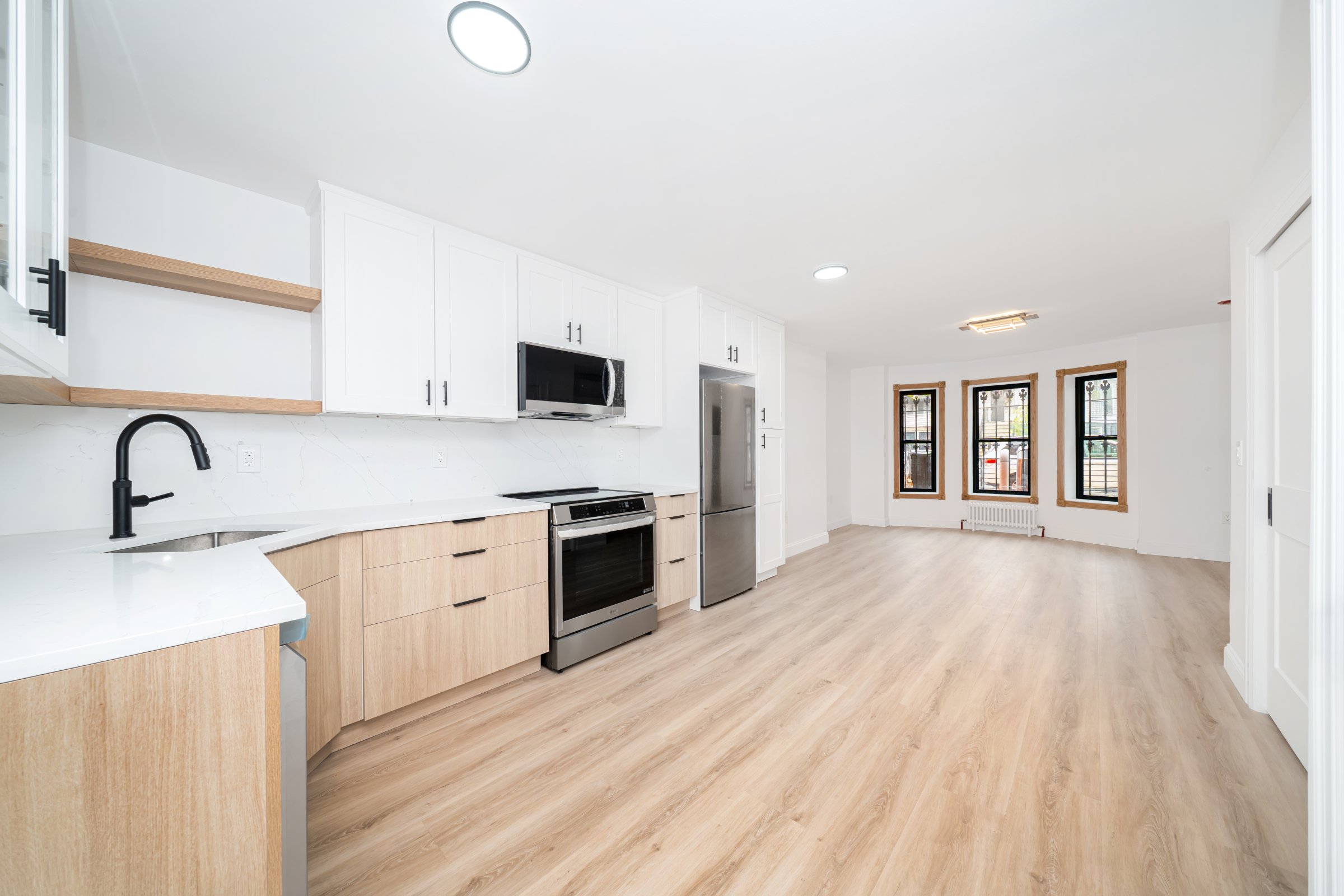 248 Eldert Street, Unit 1 Brooklyn, NY 11207 - Photo 6 of 12 a view of a kitchen with a sink and dishwasher with wooden floor