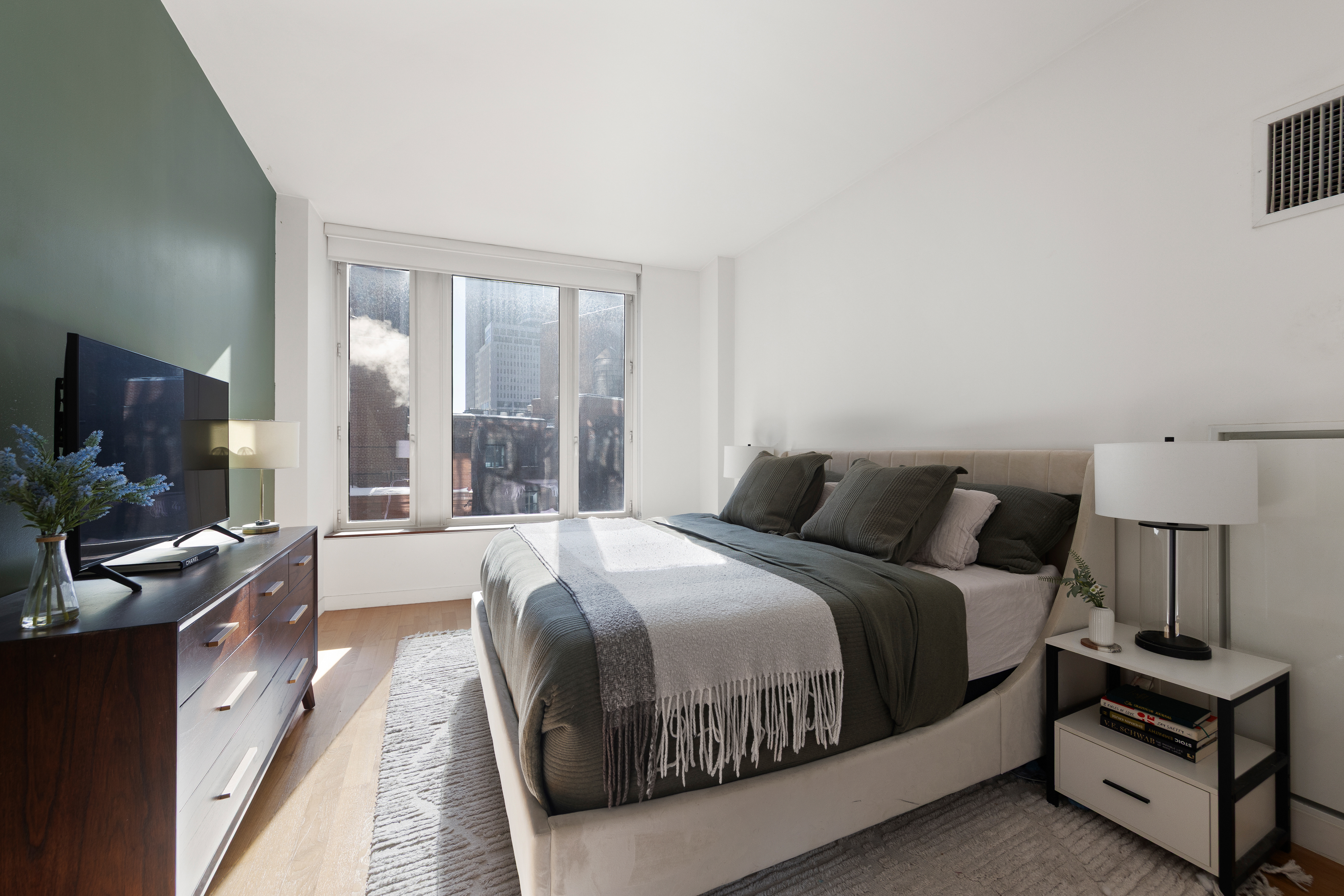 15 William Street, Unit 10C Manhattan, NY 10005 - Photo 6 of 15 a large bedroom with a bed and large window