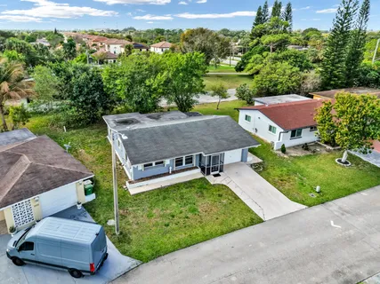 an aerial view of a house with garden space and street view