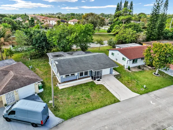an aerial view of a house with garden space and street view