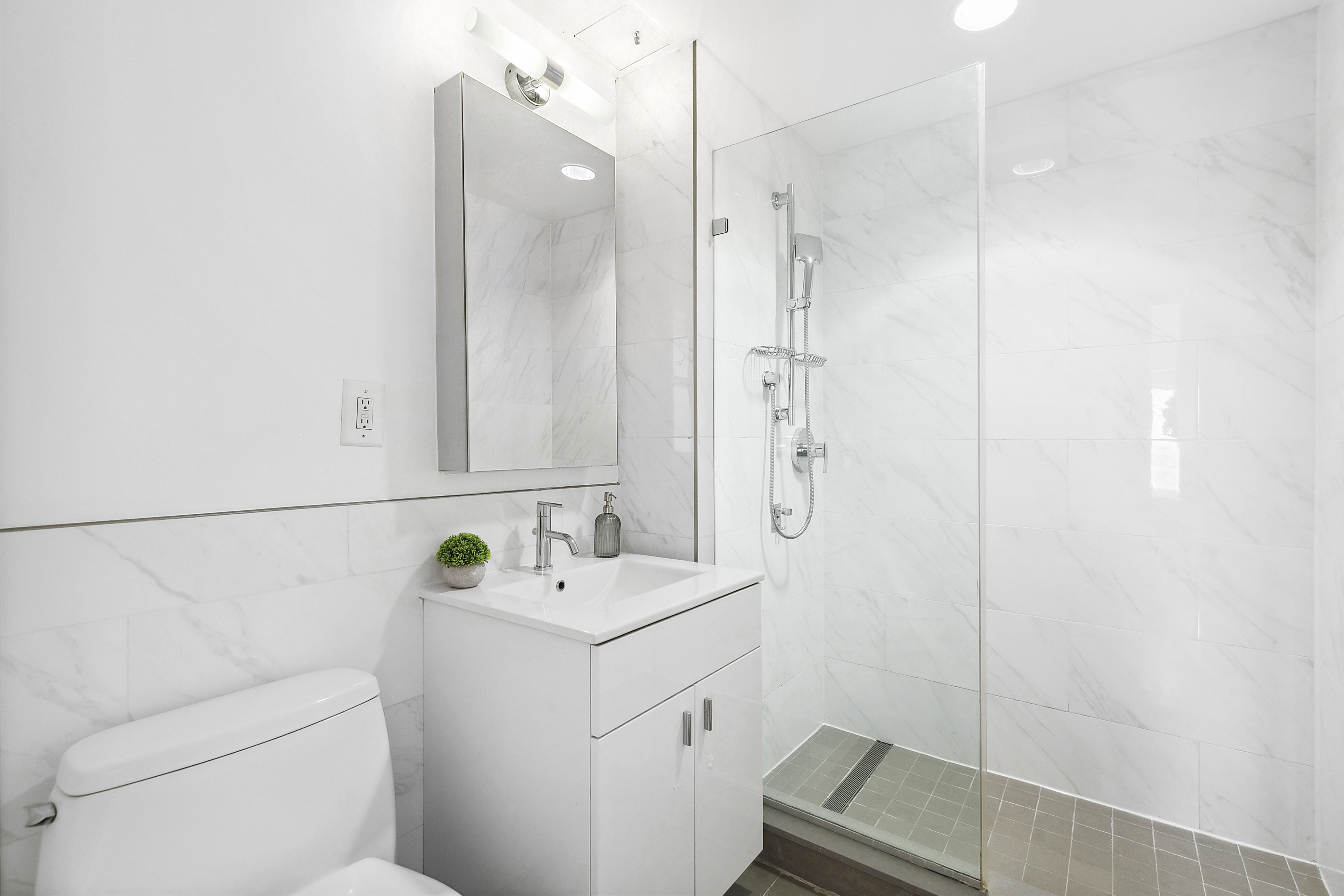 171 West 131st Street, Unit 407 Manhattan, NY 10027 - Photo 8 of 18 a bathroom with a sink a toilet and shower