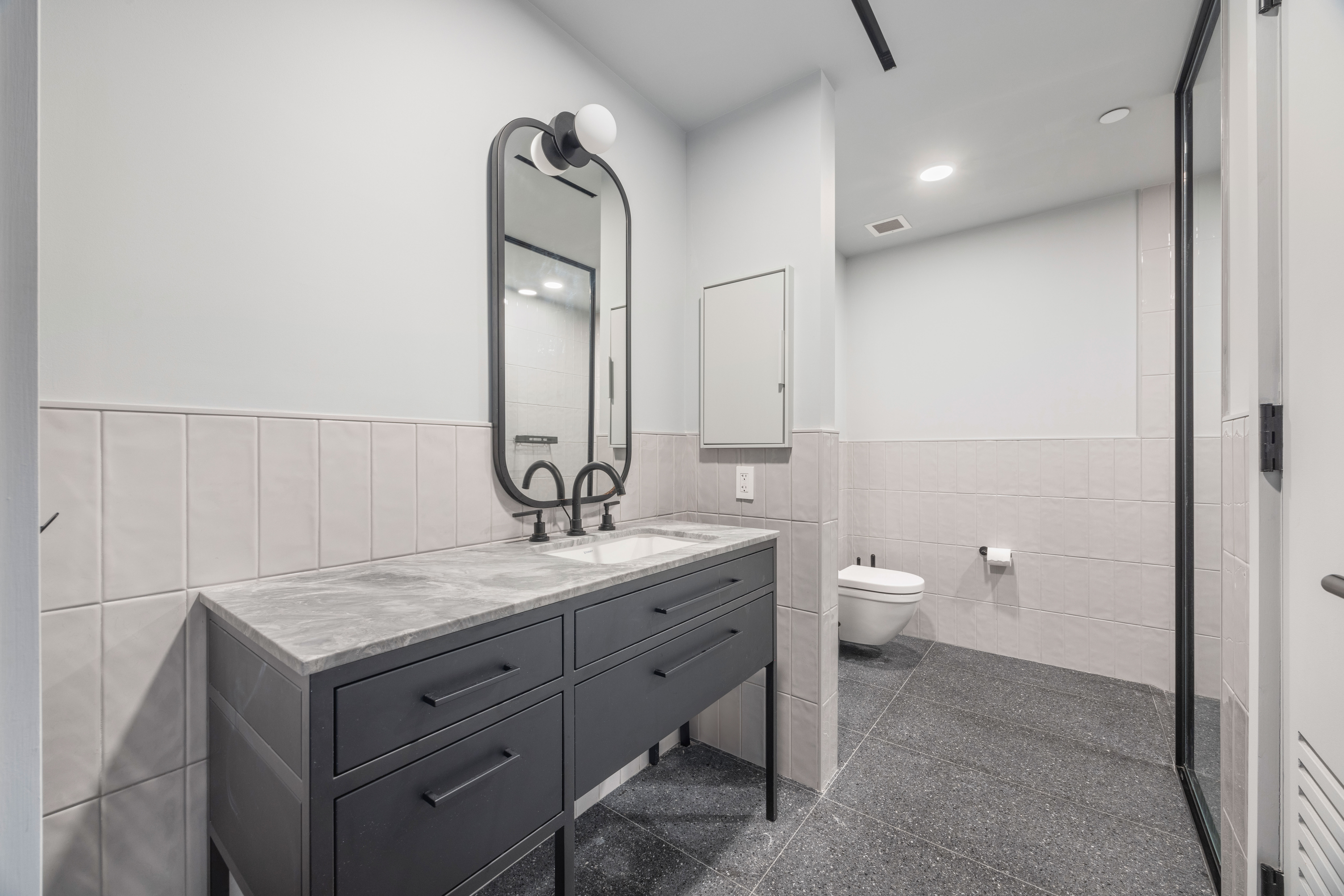 547 West 47th Street, Unit 509 Manhattan, NY 10036 - Photo 11 of 29 a bathroom with a granite countertop sink a toilet and a mirror
