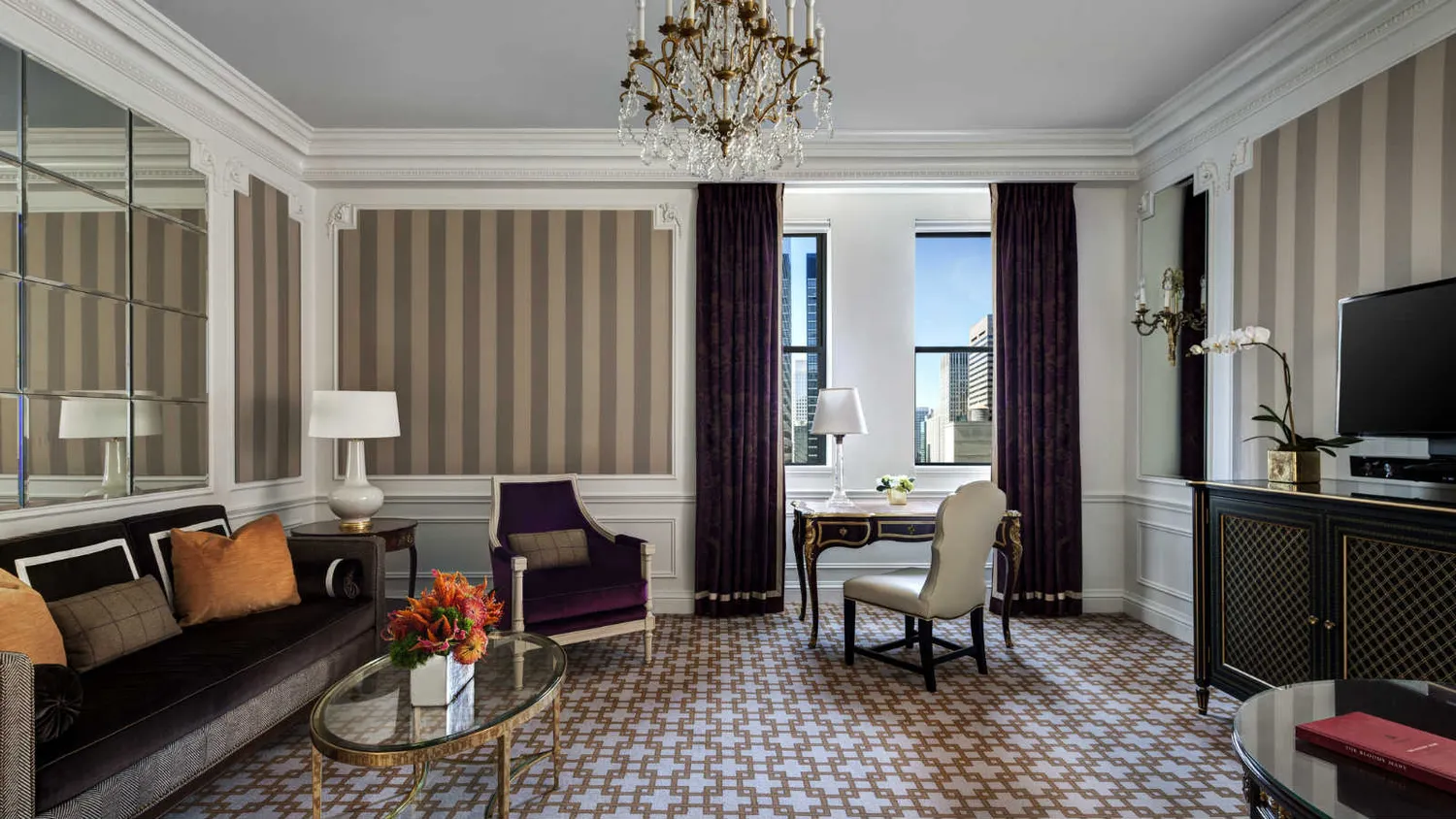 a living room with furniture a dining table and a chandelier