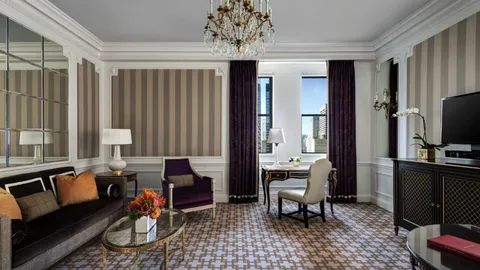 a living room with furniture a dining table and a chandelier