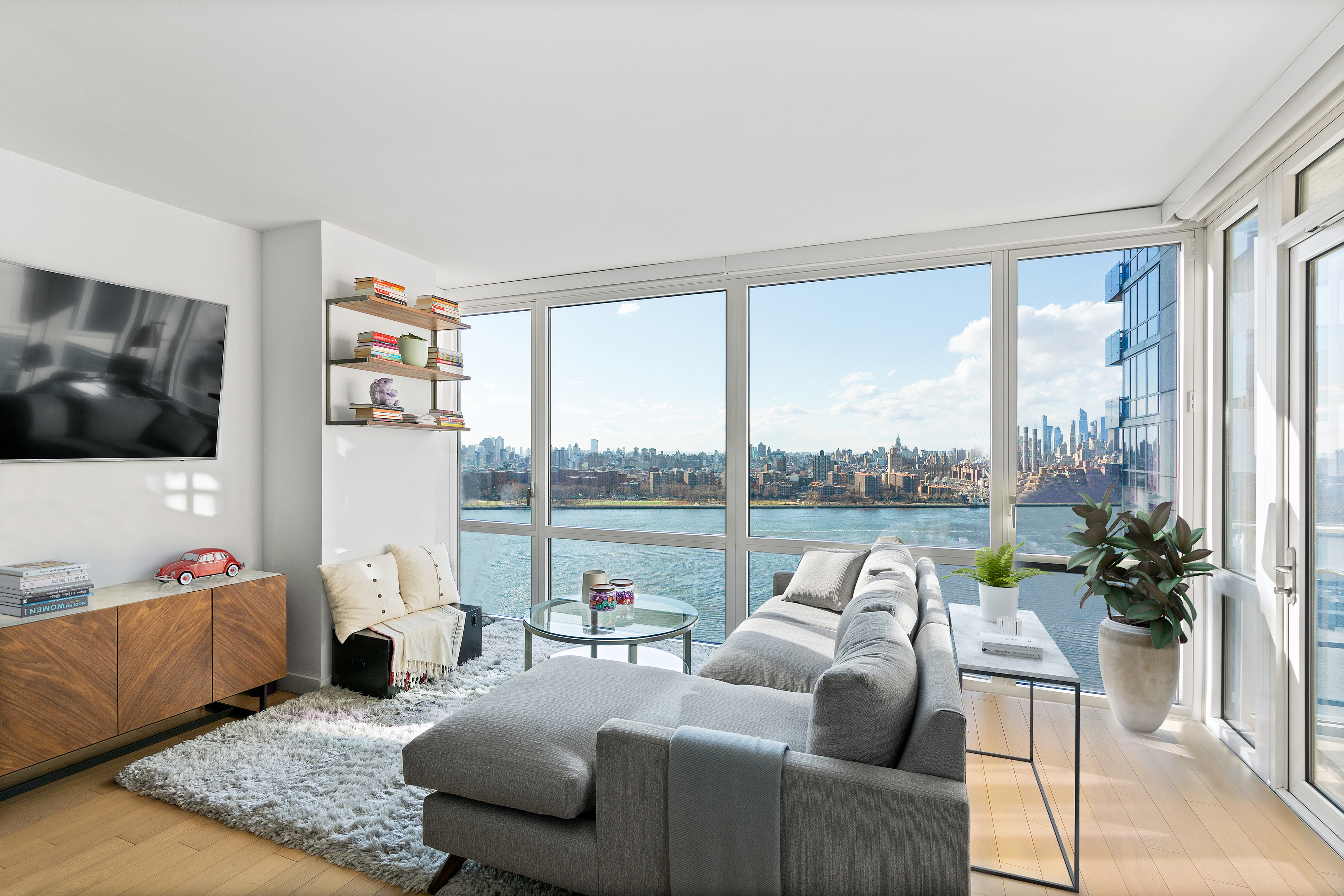 22 North 6th Street, Unit 25L Brooklyn, NY 11249 - Photo 1 of 26 a living room with furniture and a flat screen tv