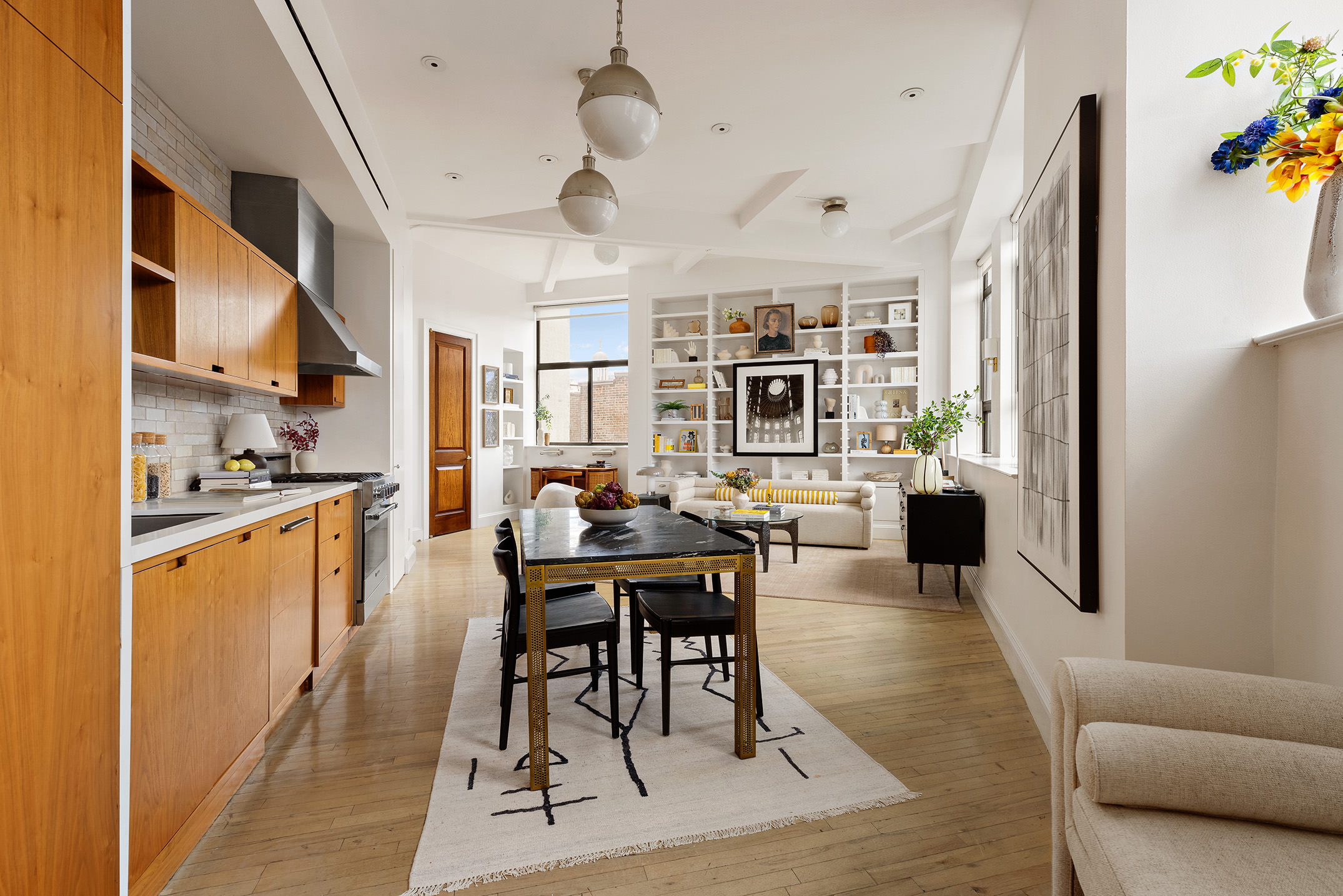 2 Cornelia Street, Unit 506 Manhattan, NY 10014 - Photo 5 of 11 a living room with stainless steel appliances kitchen island granite countertop furniture and a kitchen view