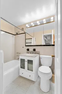a bathroom with a white toilet sitting next to a bathroom sink and a bathtub