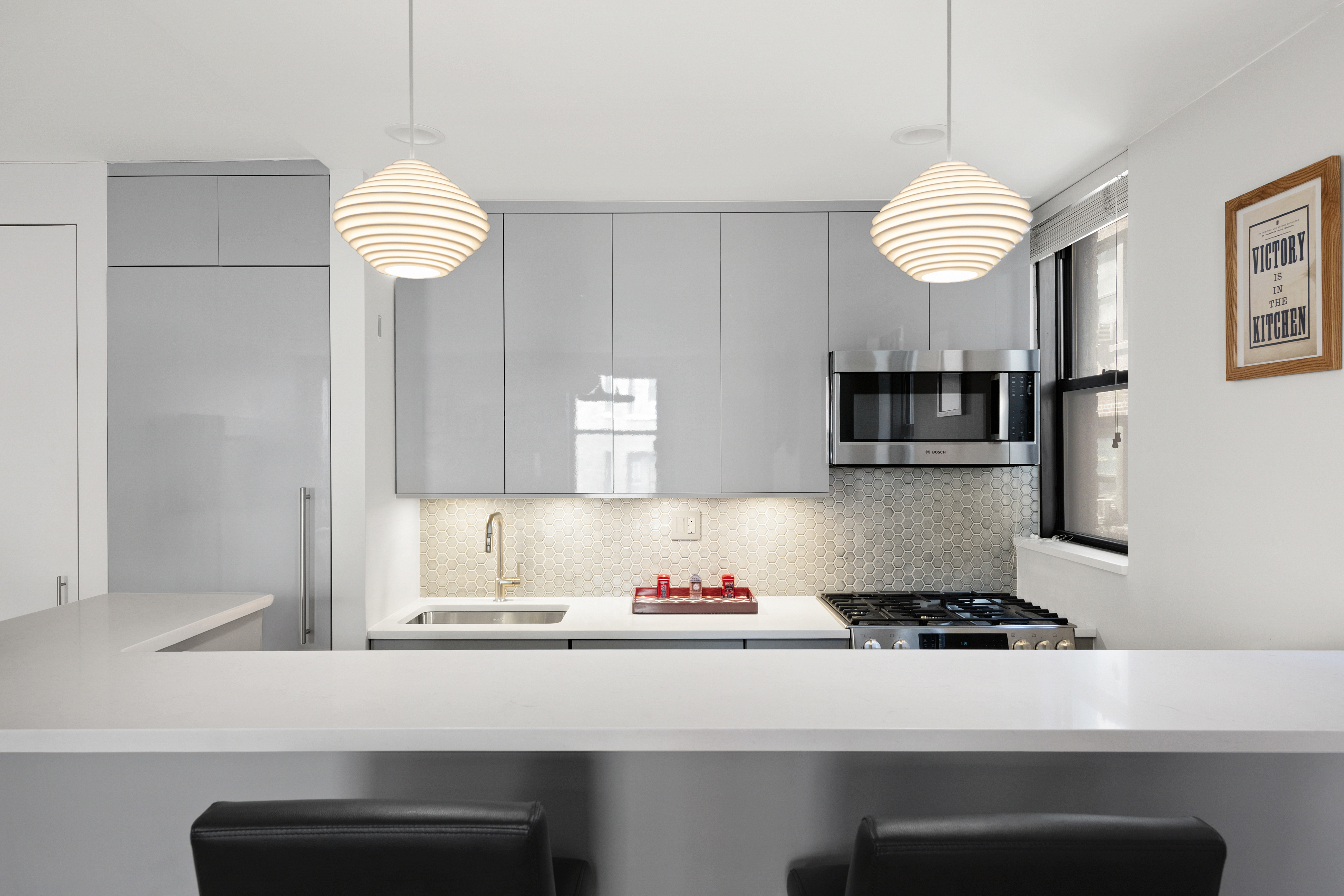 340 West 55th Street, Unit 5C Manhattan, NY 10019 - Photo 3 of 10 a kitchen with a sink cabinets and window