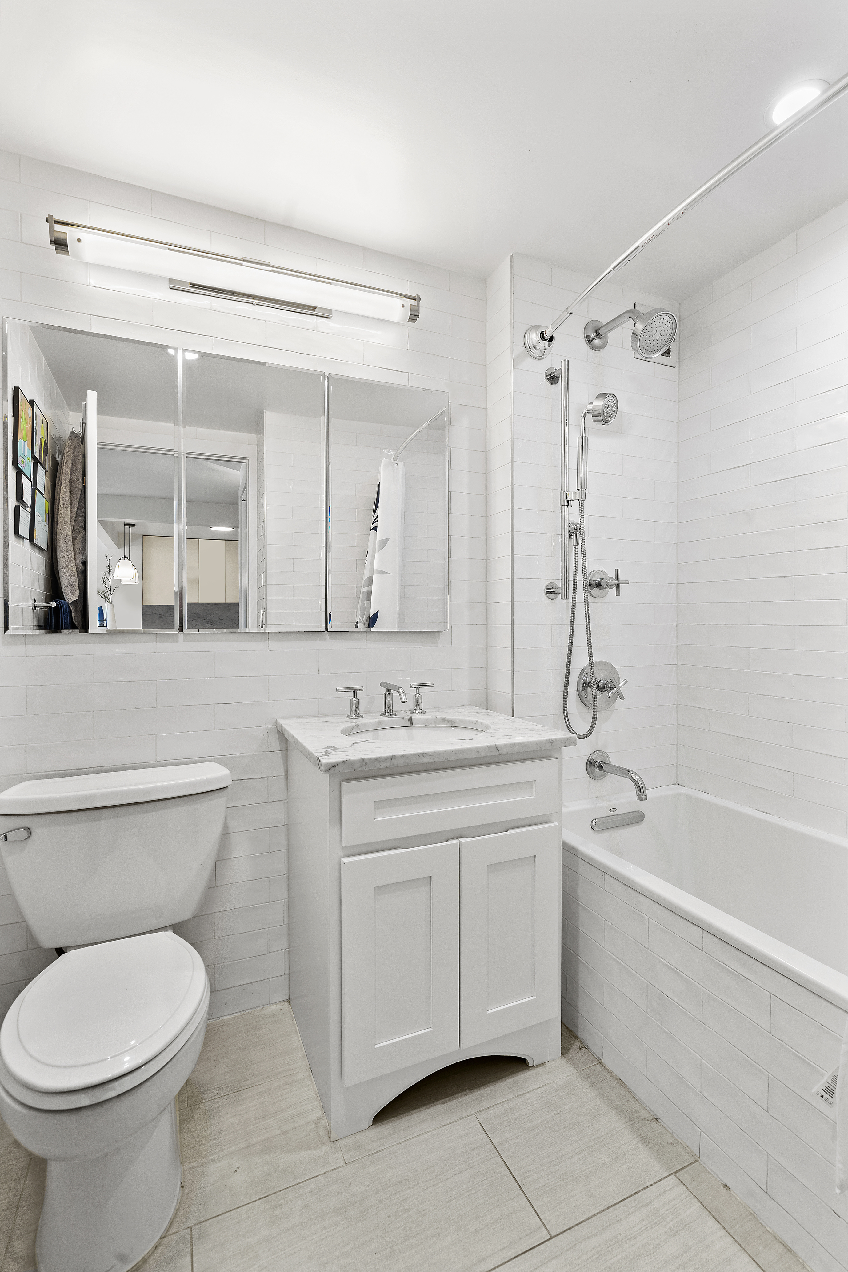 1330 5th Avenue, Unit 6H Manhattan, NY 10026 - Photo 5 of 11 a bathroom with a toilet sink and mirror