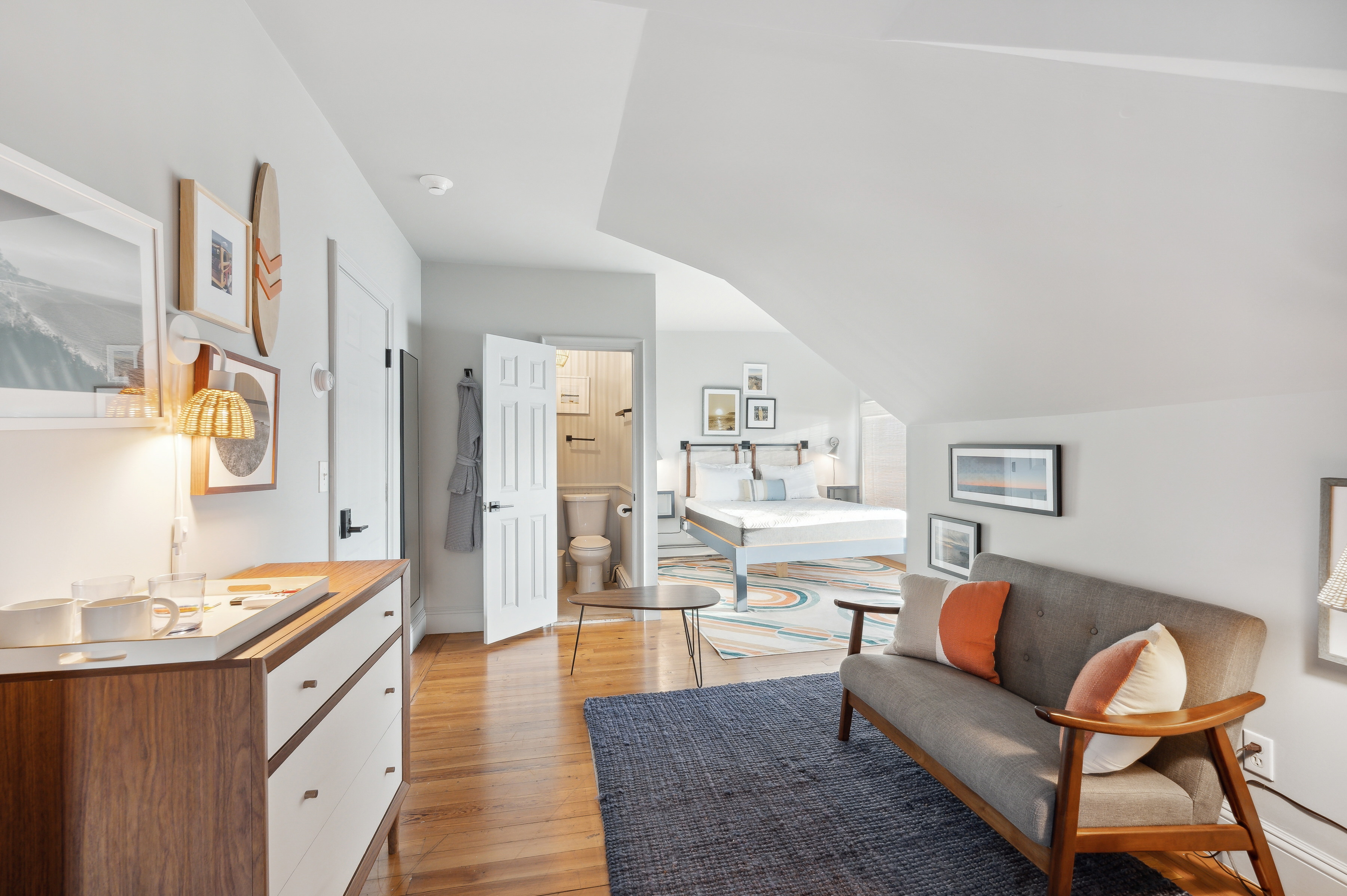 32 Lighthouse Road Hampton Bays, NY 11946 - Photo 23 of 51 a large living room with stainless steel appliances granite countertop furniture and a wooden floor