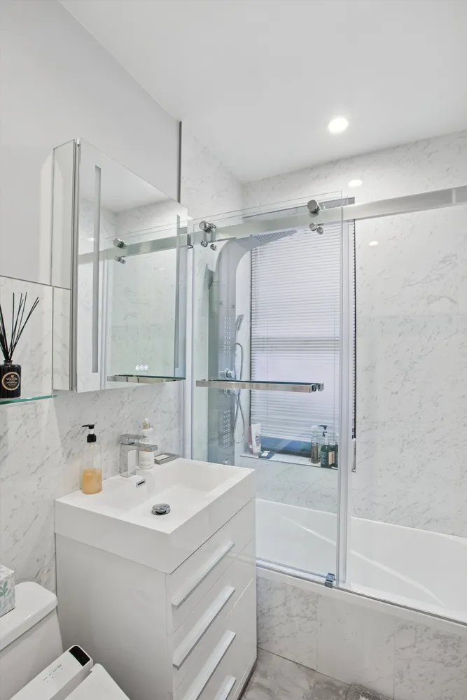 a bathroom with a sink a mirror and a bathtub