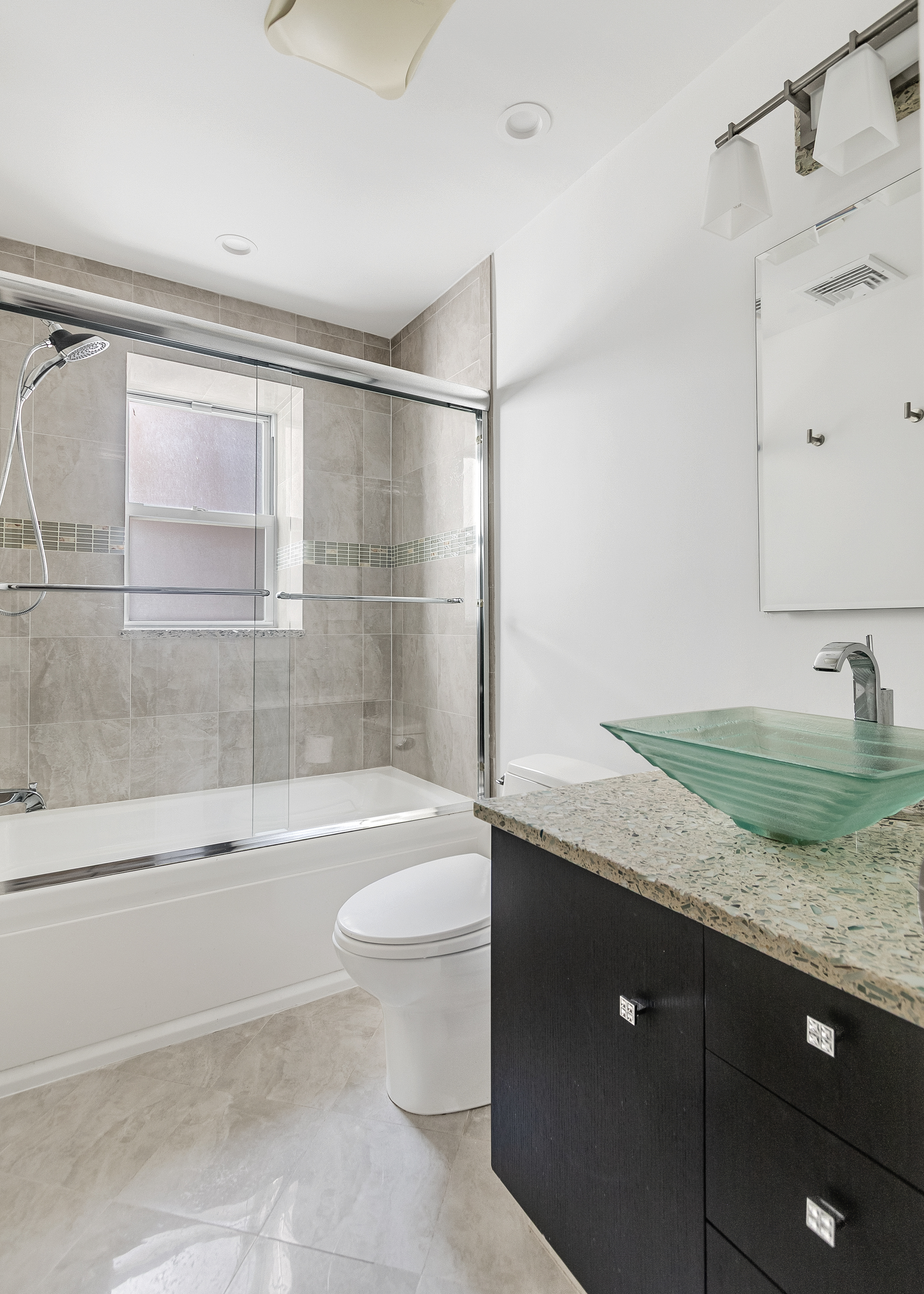 345 West 70th Street, Unit 4E Manhattan, NY 10023 - Photo 7 of 11 a bathroom with a granite countertop sink toilet and shower