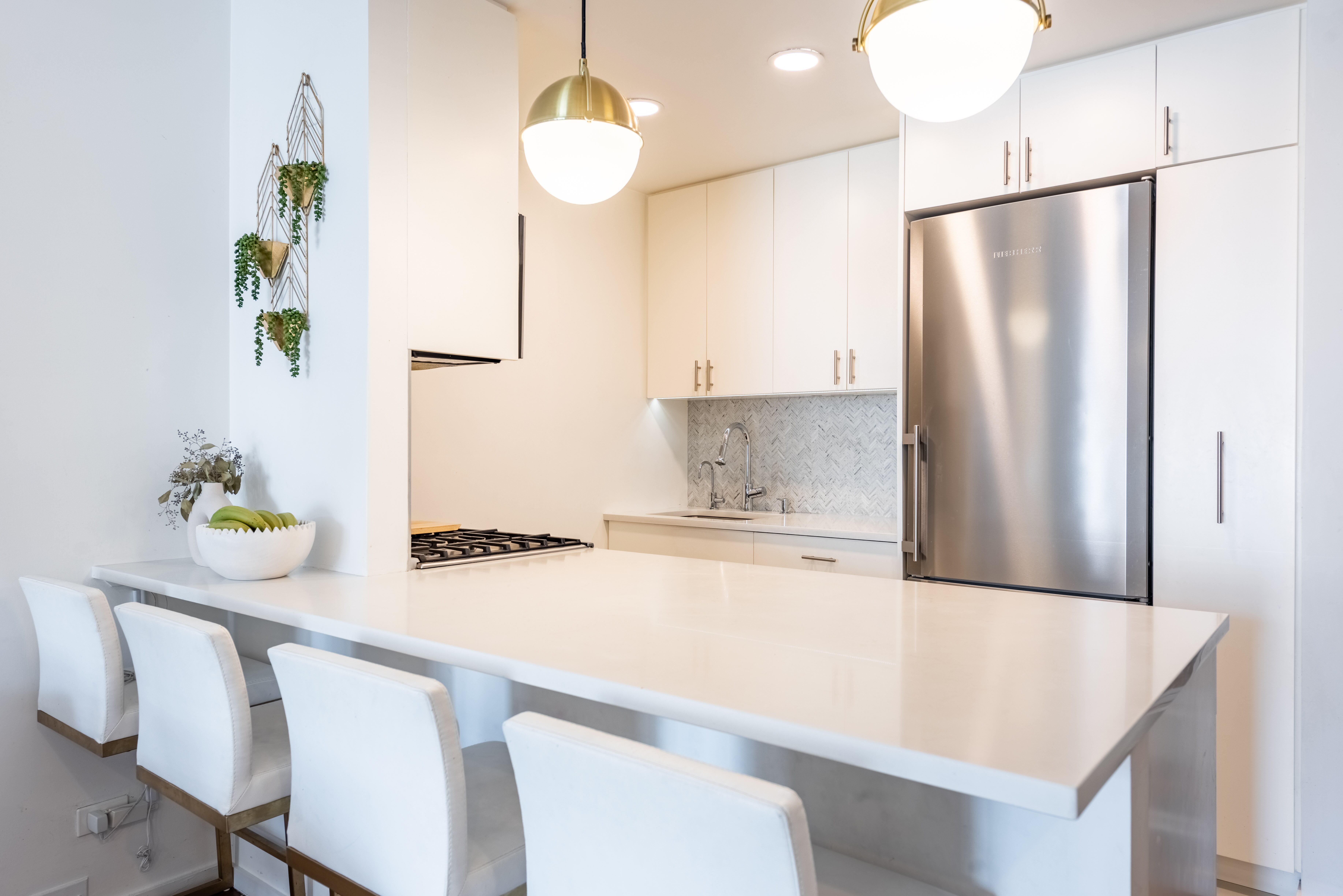 2373 Broadway, Unit 630 Manhattan, NY 10024 - Photo 2 of 17 a kitchen with kitchen island a counter space and a refrigerator