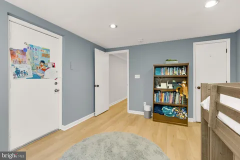 a view of an empty room with window and cabinet