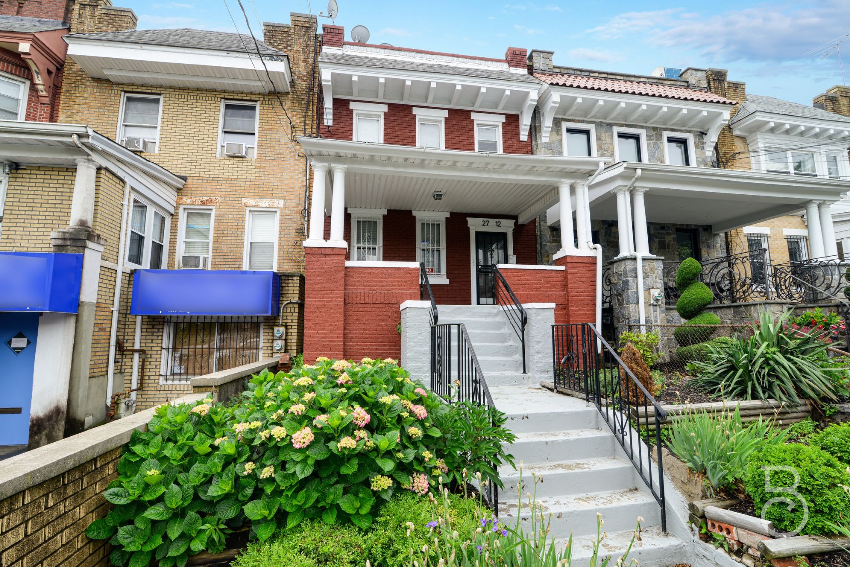 a front view of a house with lots of green space