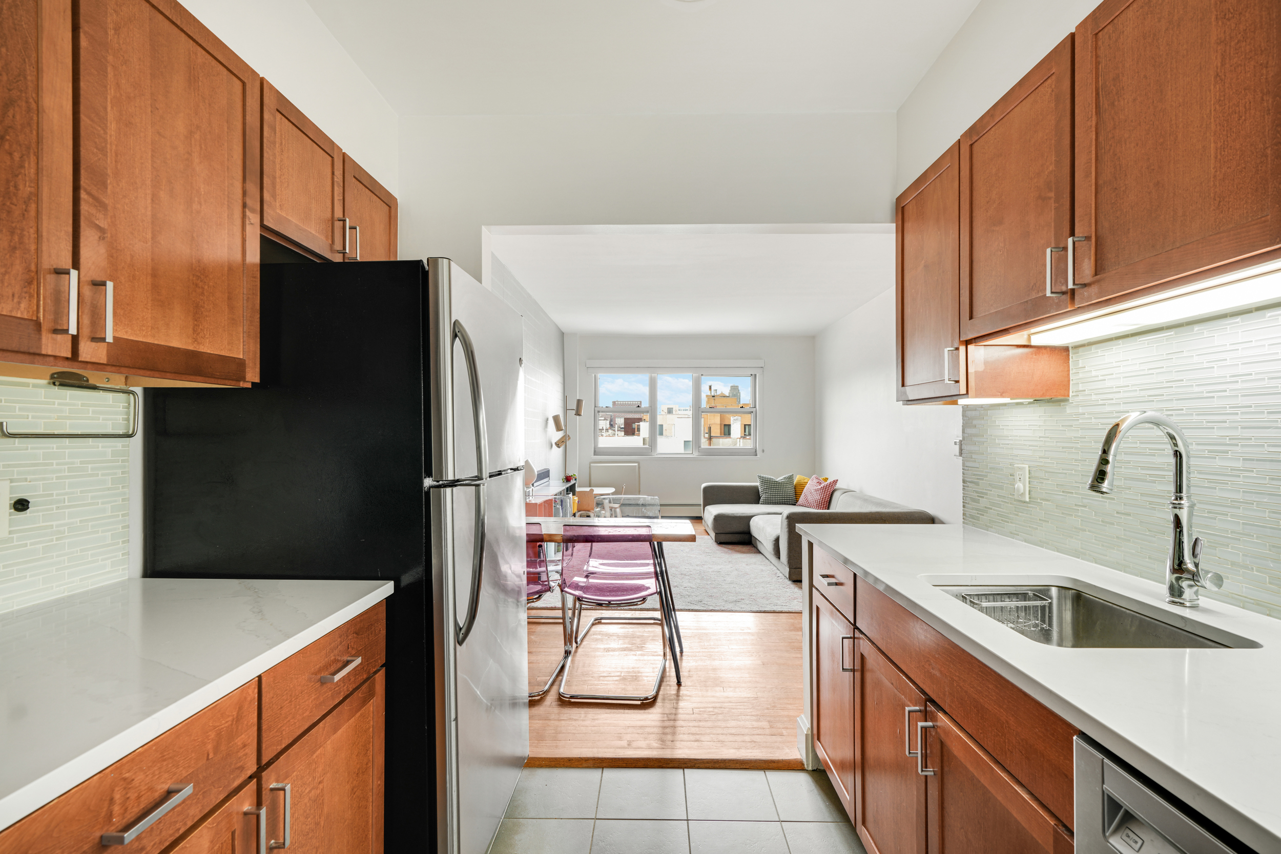 1820 Madison Avenue, Unit 7C Manhattan, NY 10035 - Photo 5 of 17 a kitchen with a sink a refrigerator and cabinets
