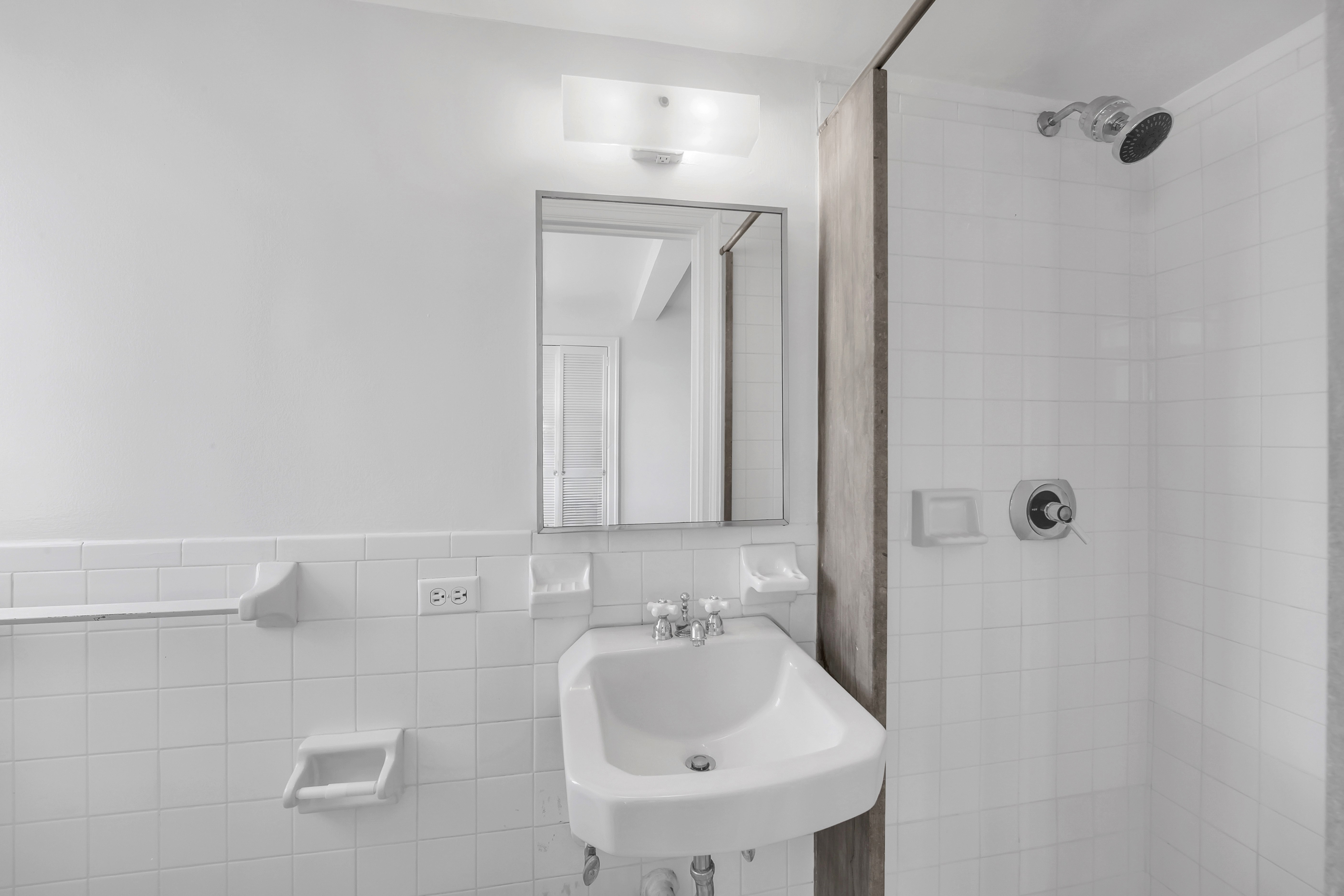 5 Tudor City Place, Unit 1126 Manhattan, NY 10017 - Photo 14 of 20 a bathroom with a sink and a mirror