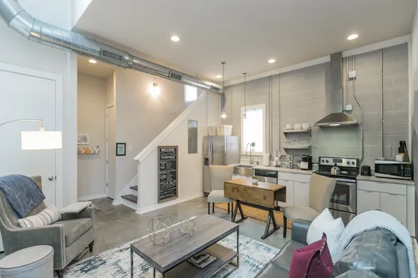a very nice looking living room with a couch and a view of kitchen