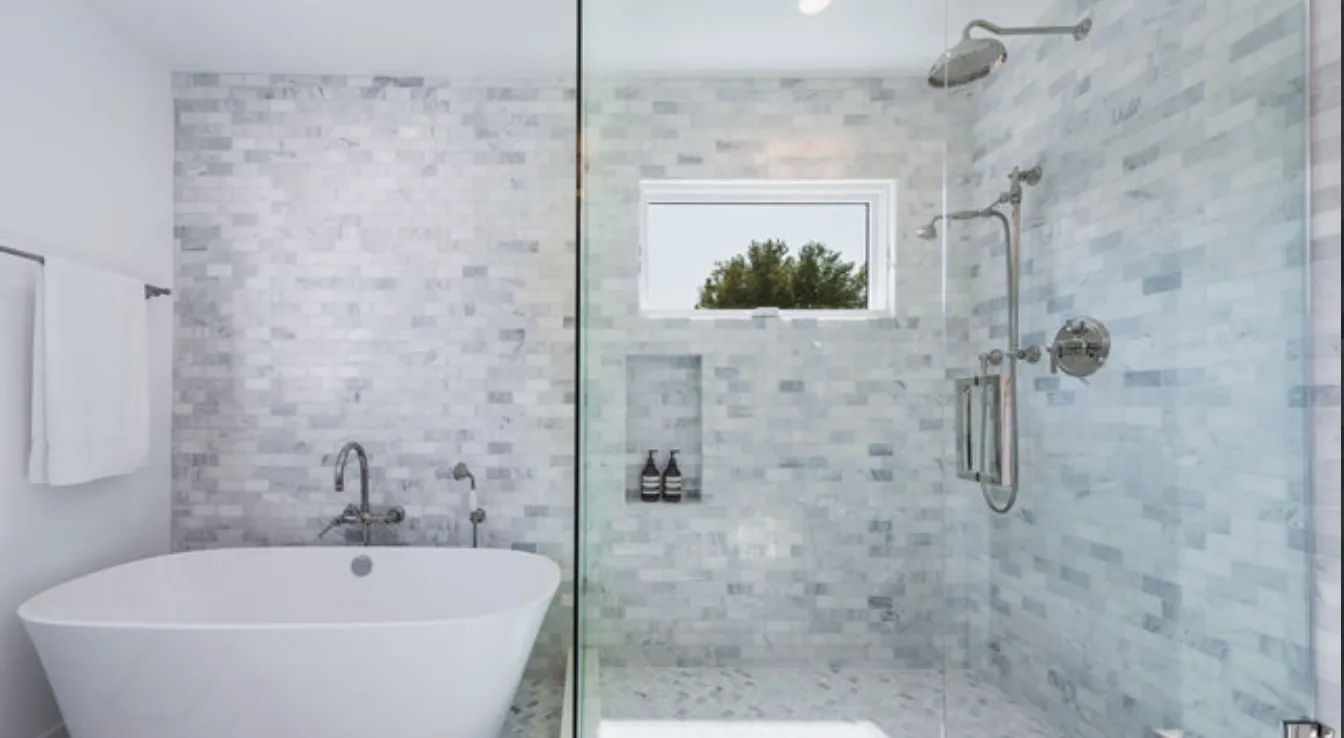 a white bath tub sitting next to a shower