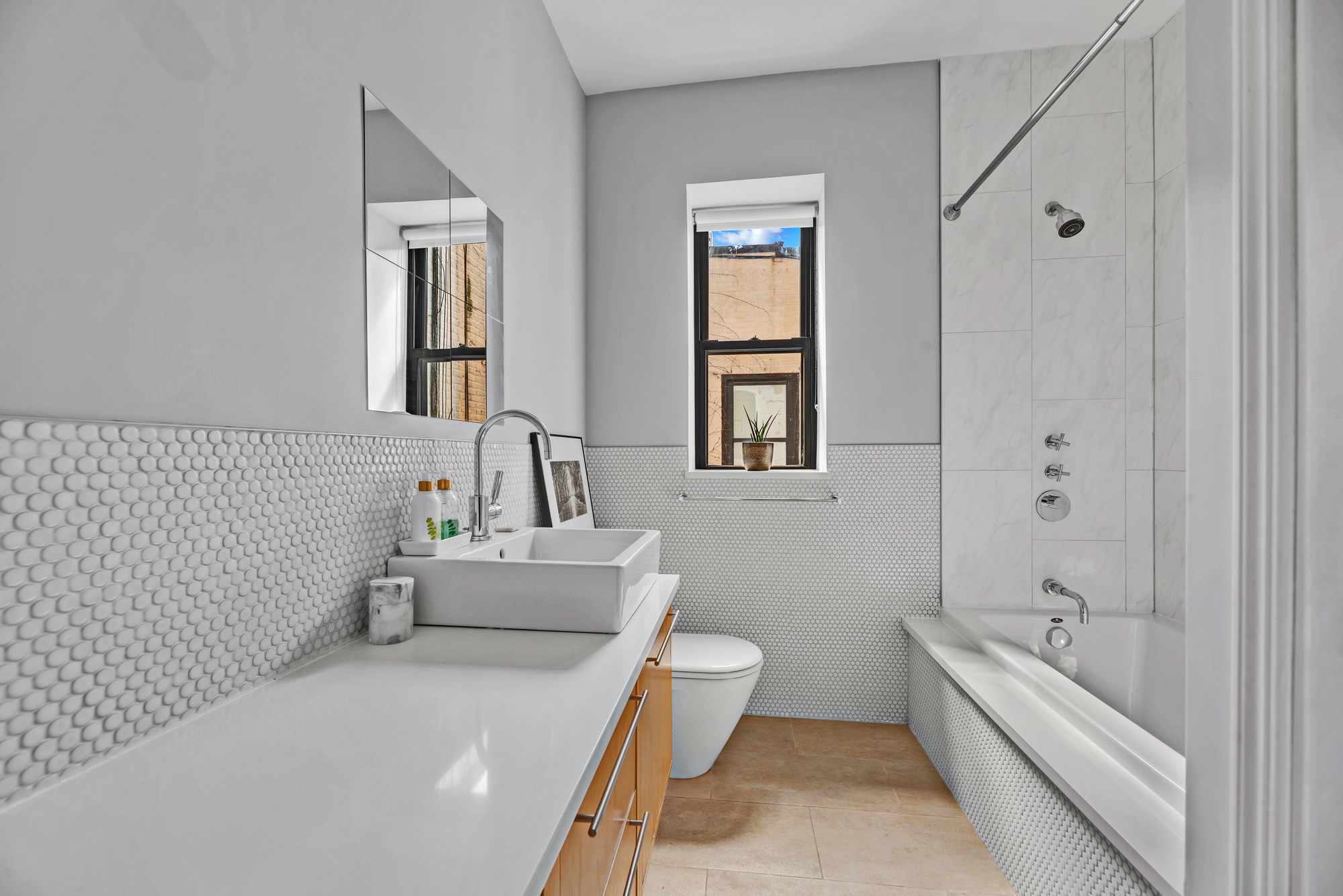 72 East 93rd Street, Unit 5 Manhattan, NY 10128 - Photo 14 of 17 a bathroom with a bathtub sink and toilet
