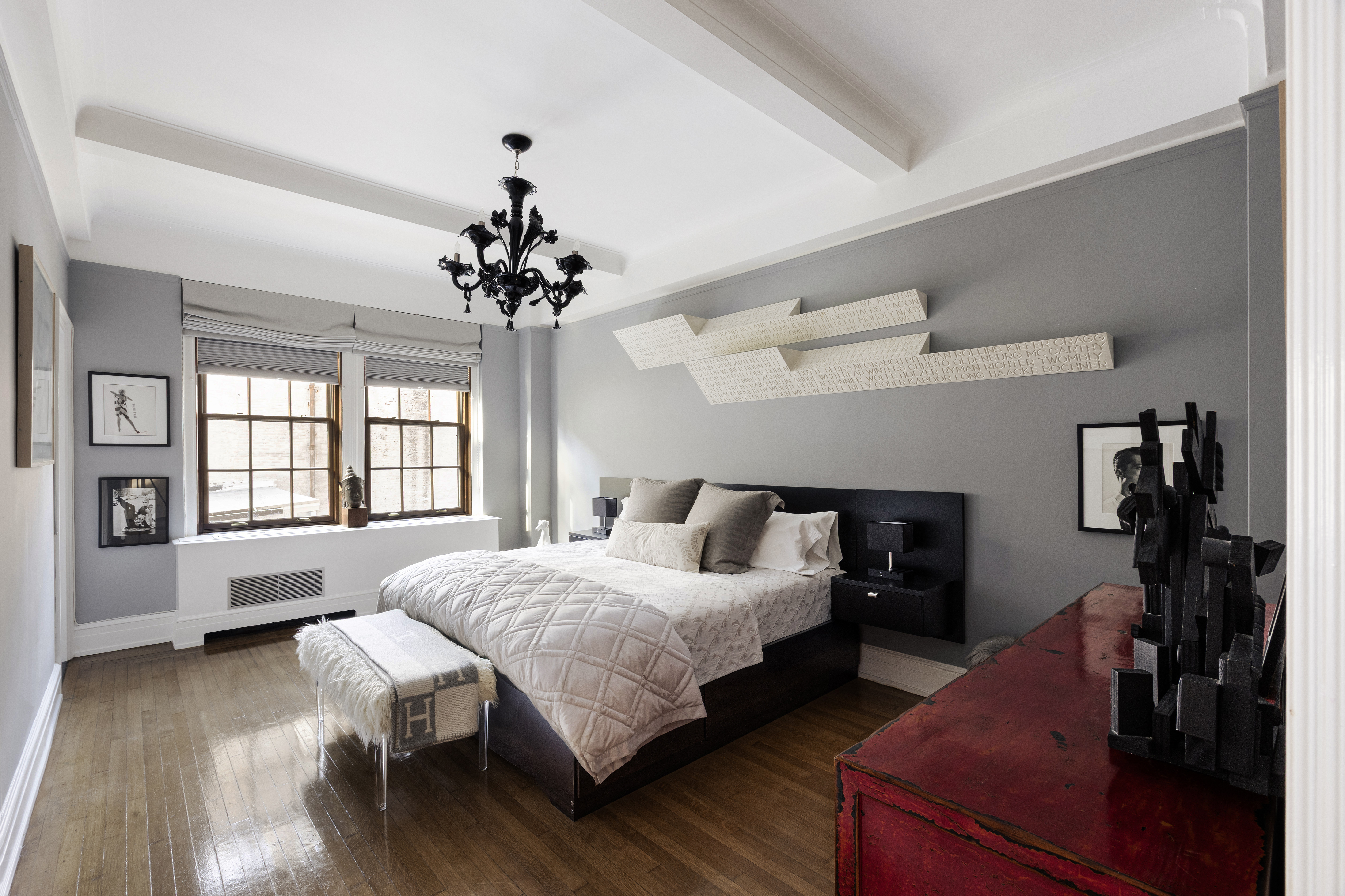 14 East 75th Street, Unit 7E Manhattan, NY 10021 - Photo 6 of 13 a spacious bedroom with a bed and a chandelier
