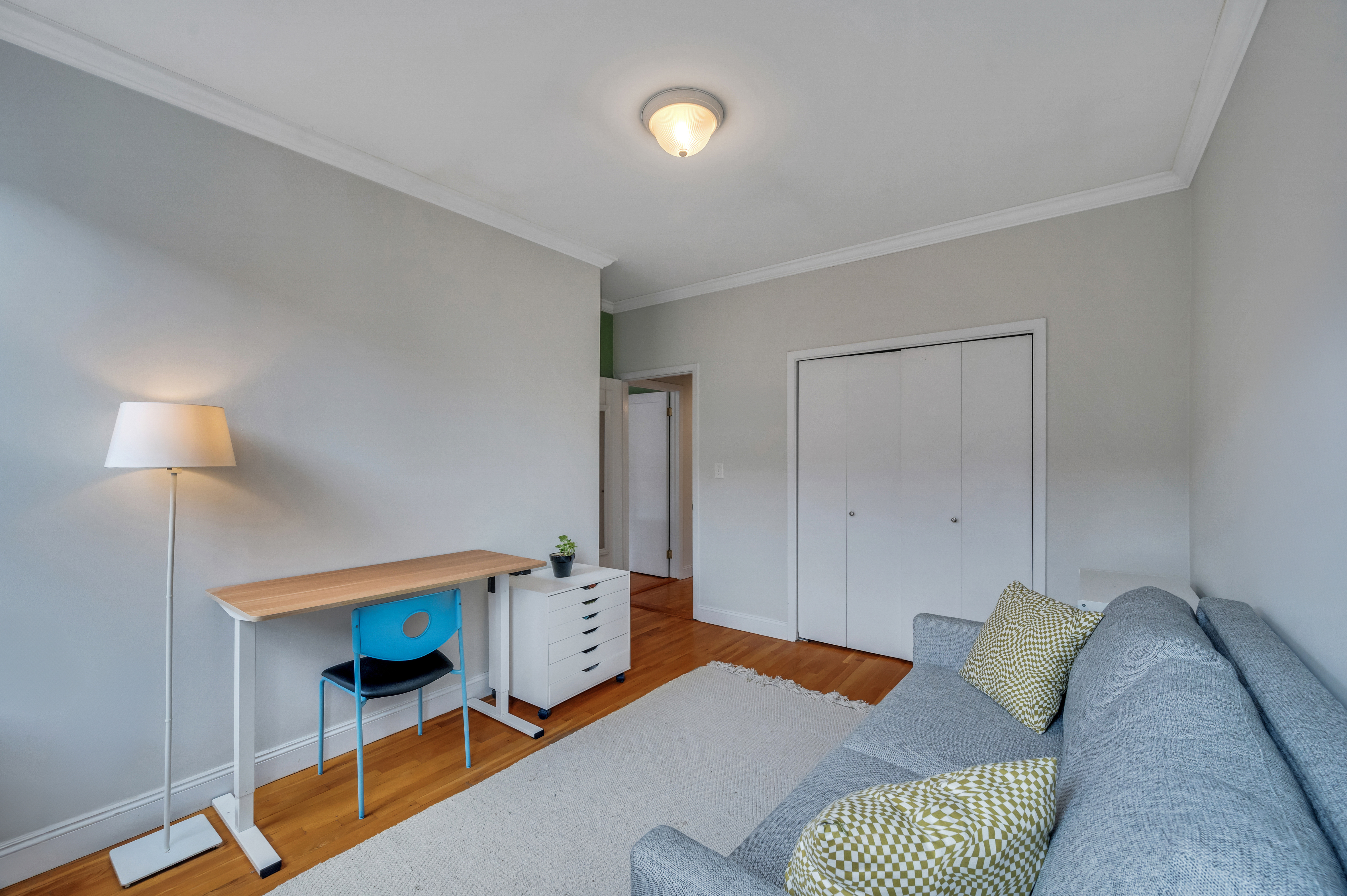 120 2nd Avenue, Unit 5A Manhattan, NY 10003 - Photo 10 of 13 a bedroom with furniture and a lamp