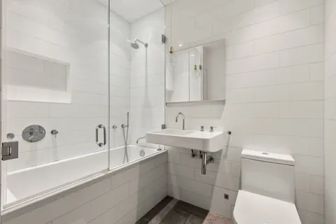 a bathroom with a sink a toilet and bathtub