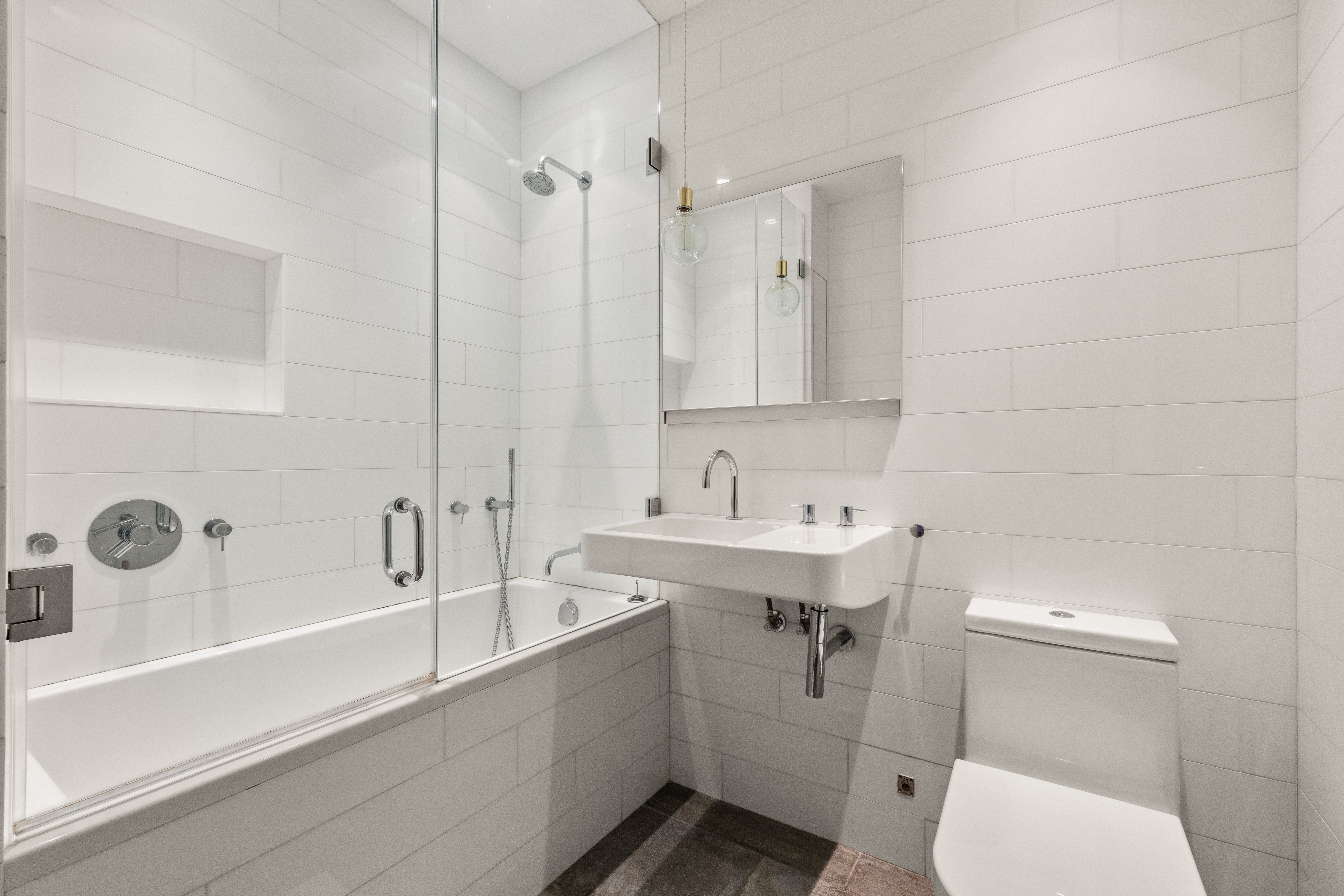 35 Vestry Street, Unit 4 Manhattan, NY 10013 - Photo 9 of 11 a bathroom with a sink a toilet and bathtub