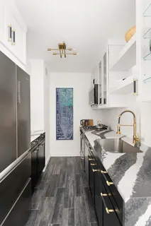 a kitchen with stainless steel appliances granite countertop hardwood floor sink stove and refrigerator