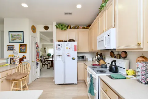 a kitchen with stainless steel appliances granite countertop a refrigerator and a sink