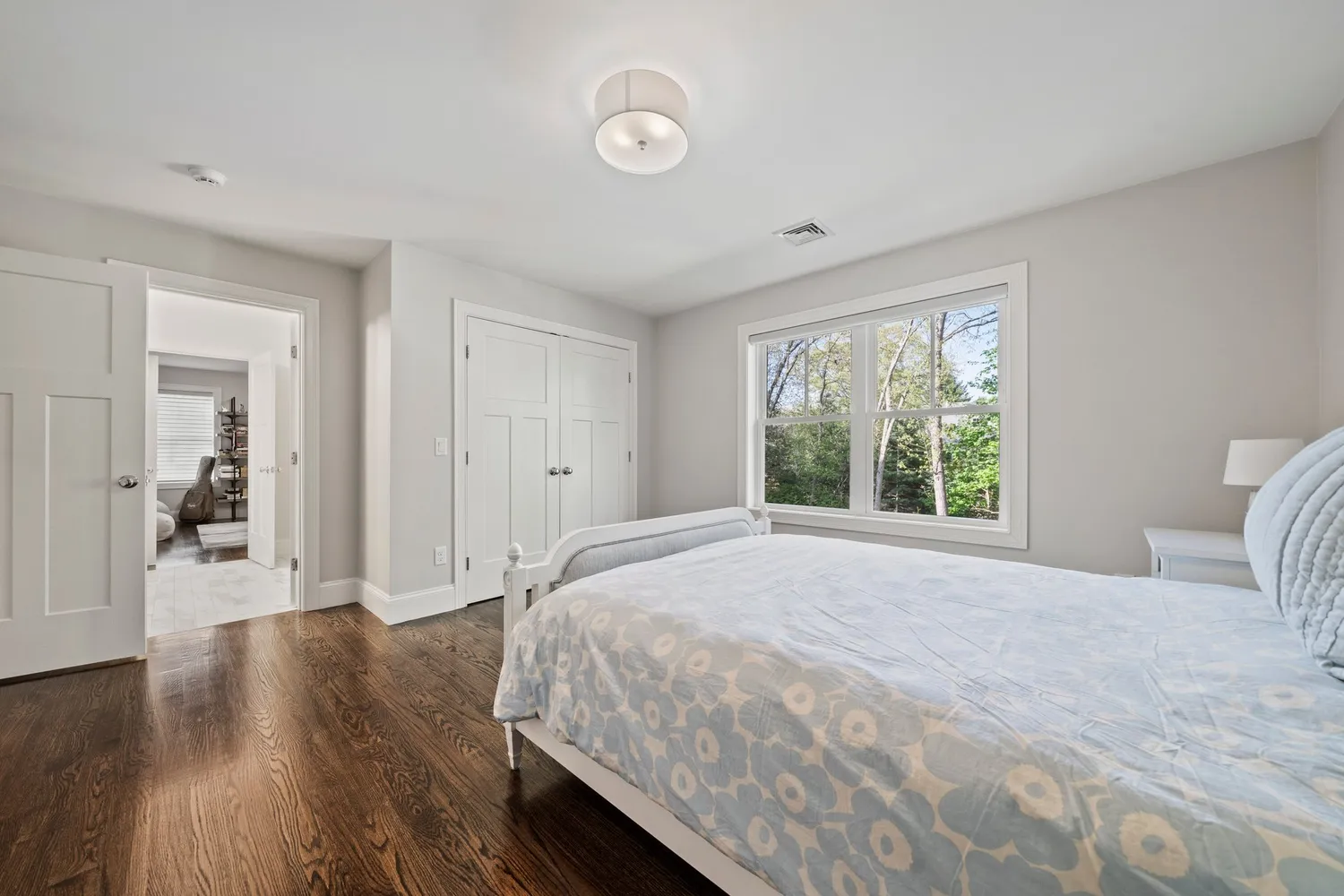 a spacious bedroom with a bed a book shelf and a book shelf