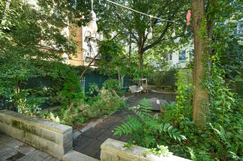 a backyard of a house with lots of green space and fountain