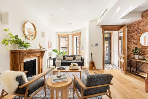 a living room with fireplace furniture and a fireplace