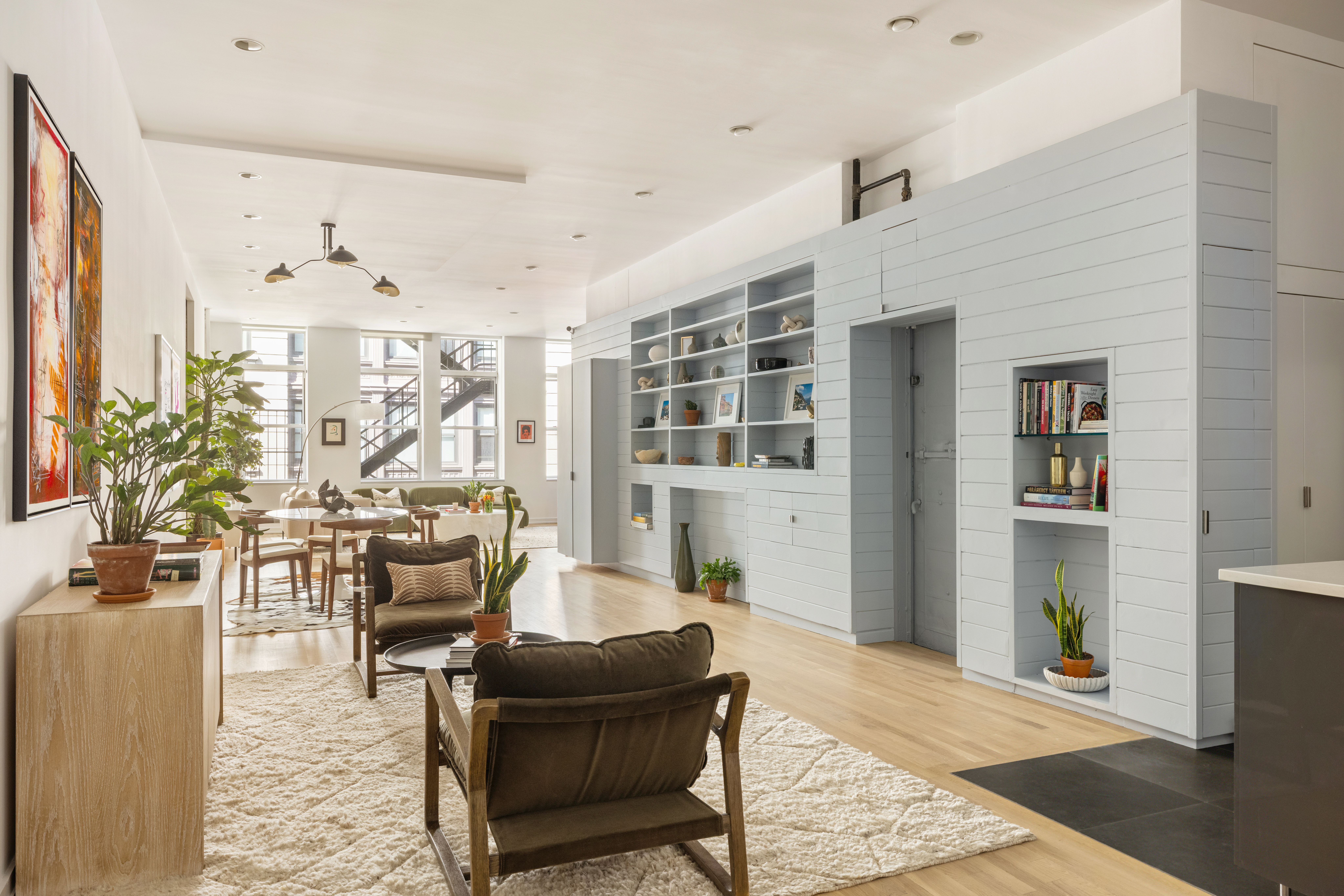 56 East 11th Street, Unit 5 Manhattan, NY 10003 - Photo 5 of 18 a living room with furniture and large windows