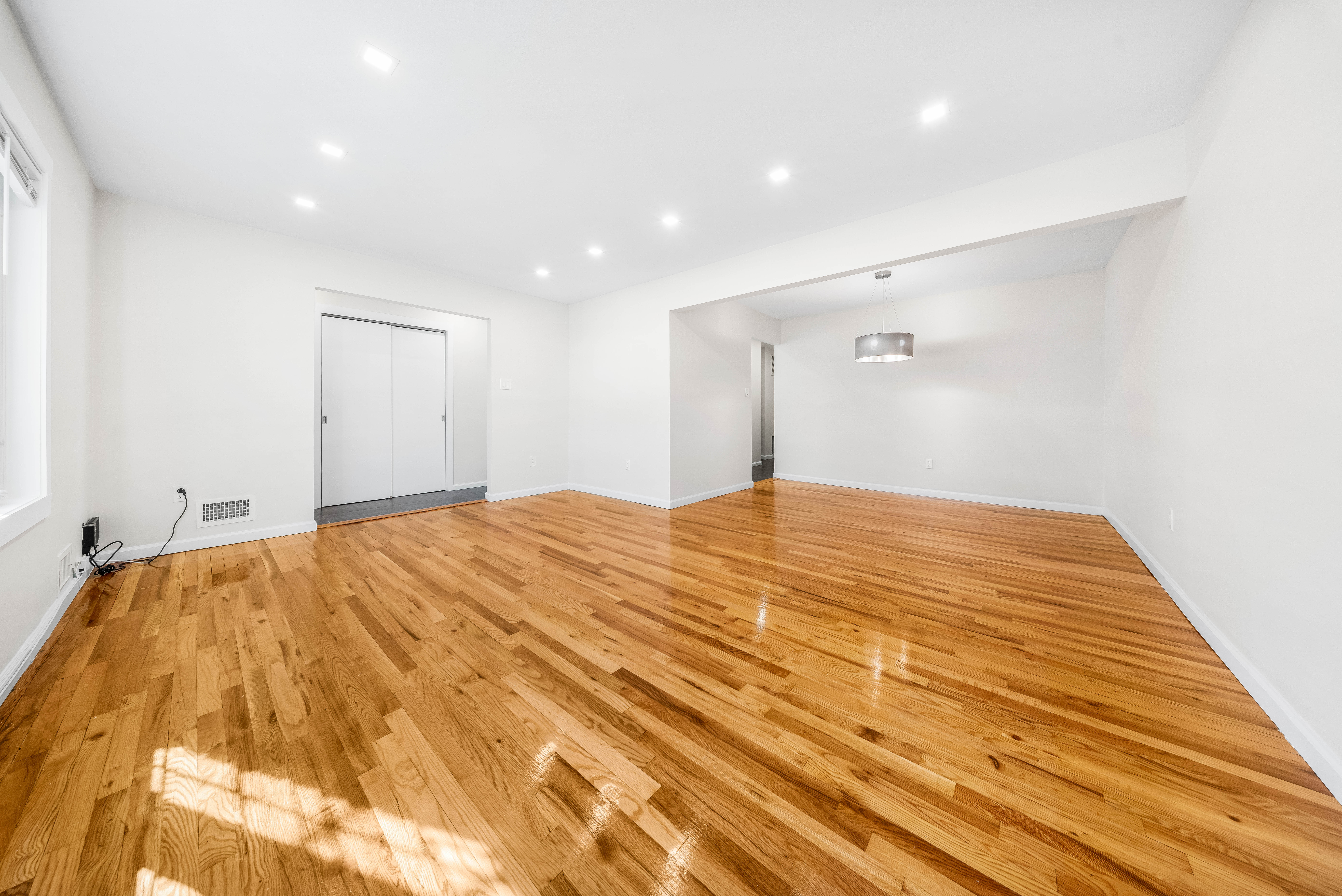 15-80 209th Street, Unit 2 Queens, NY 11360 - Photo 4 of 21 a bedroom with a bed and a mirror