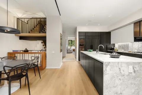 a kitchen with granite countertop a sink and cabinets