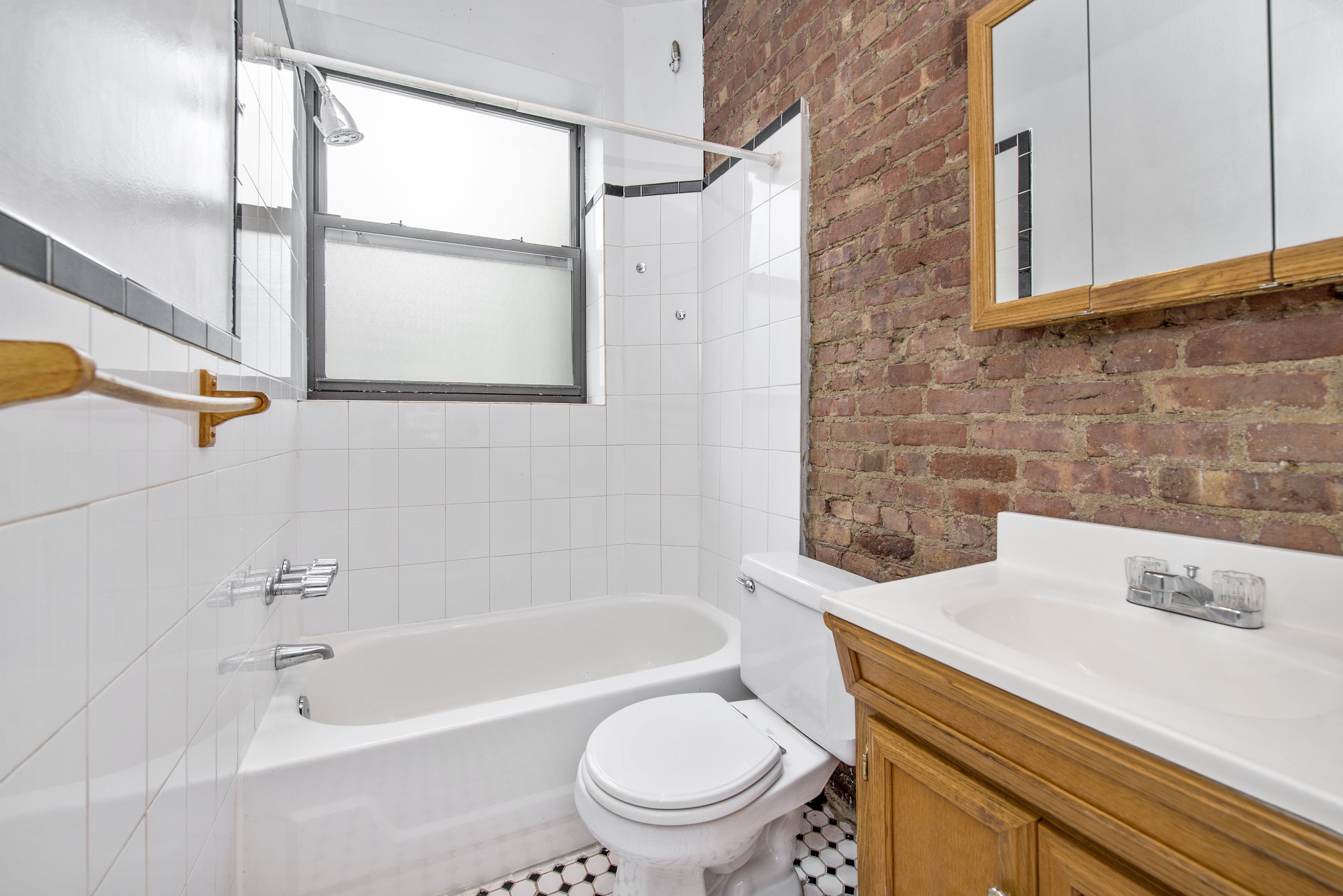 309 East 95th Street, Unit 23 Manhattan, NY 10128 - Photo 6 of 6 a bathroom with a sink a toilet and a bathtub