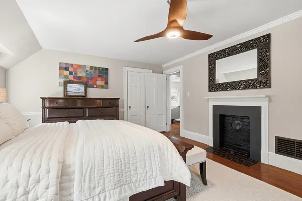 a bedroom with a large bed and a chandelier