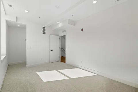 a view of hallway with stairs and wooden floor