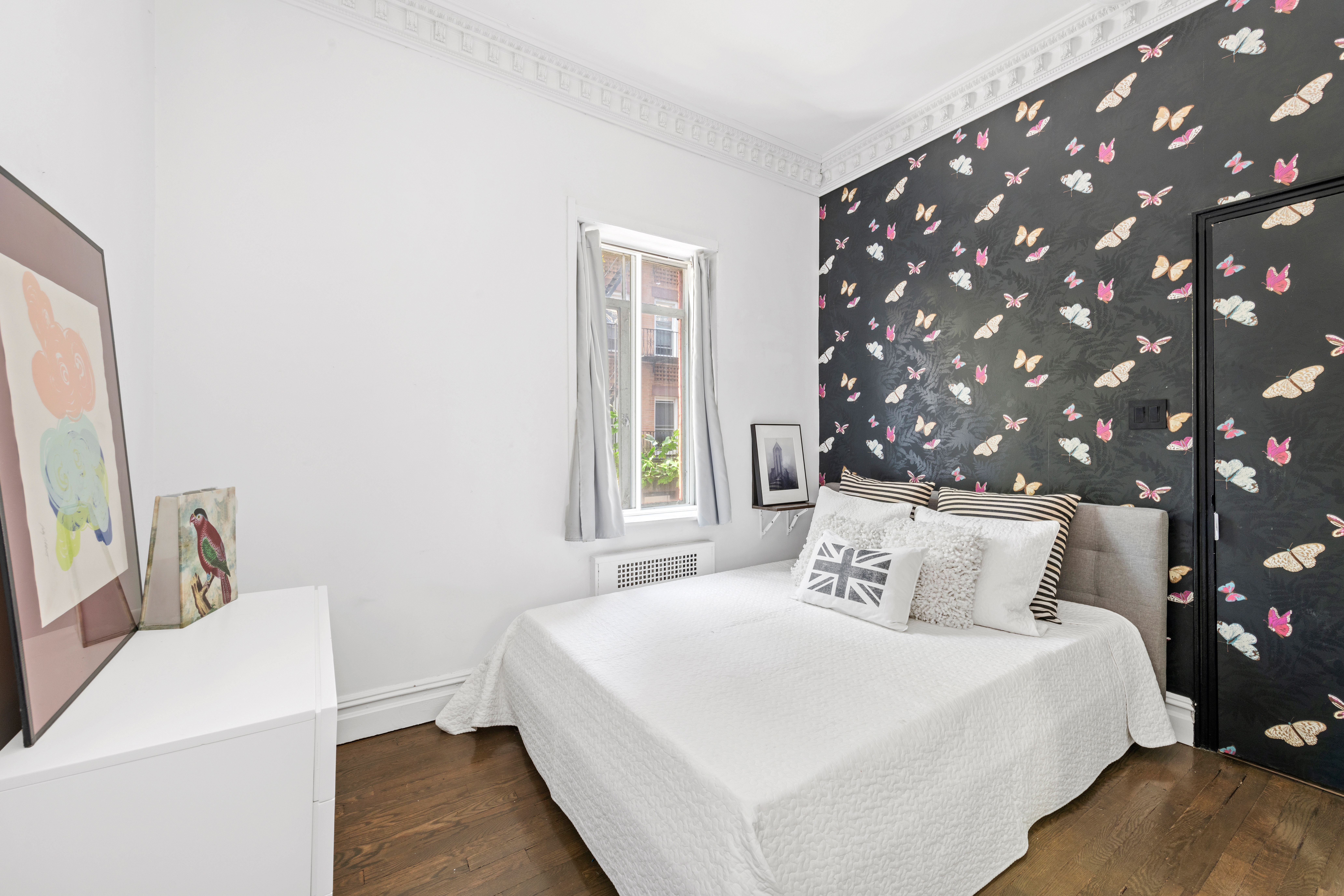 32 Downing Street, Unit 2D Manhattan, NY 10014 - Photo 6 of 9 a bedroom with a bed and a large window